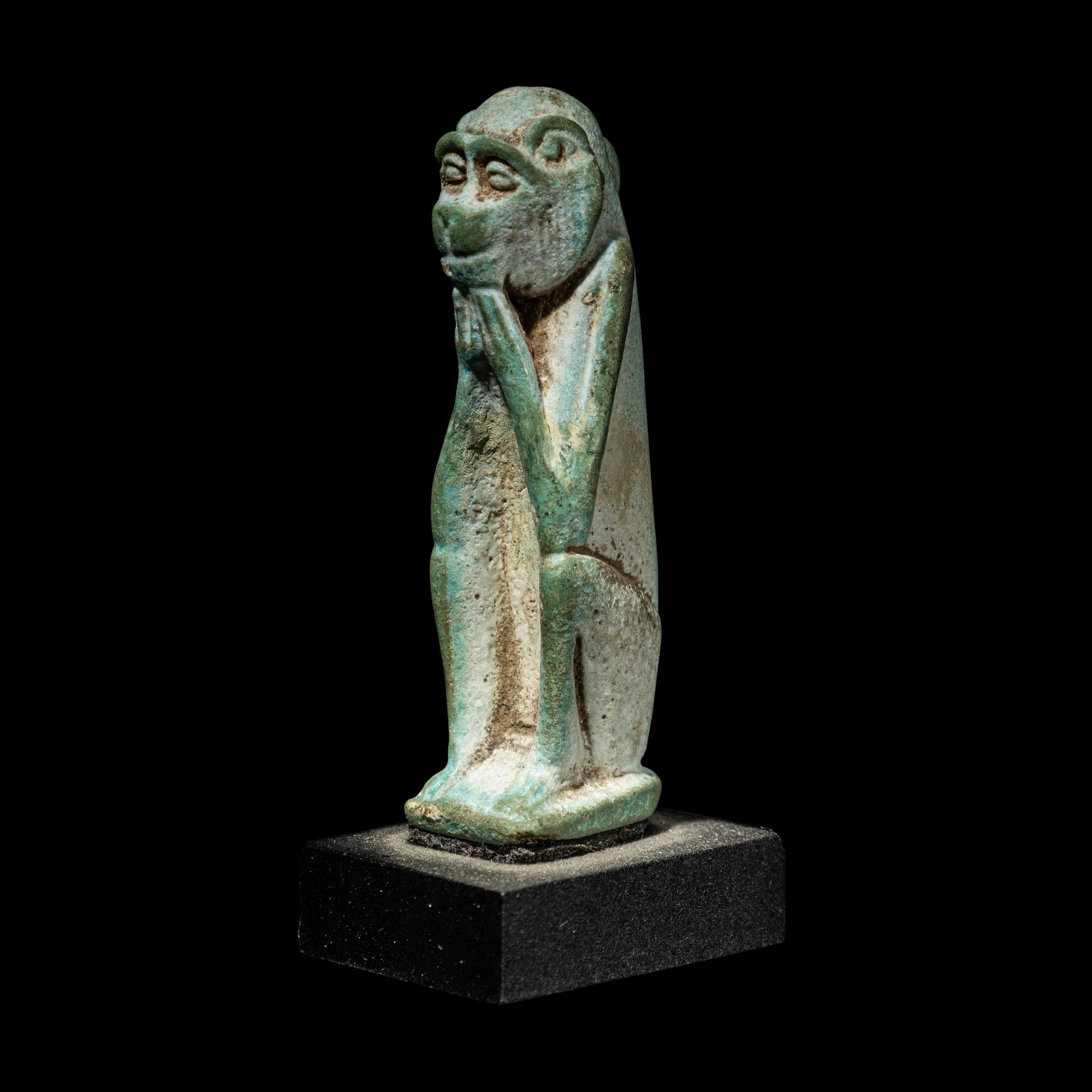 An Egyptian Faience Seated Monkey