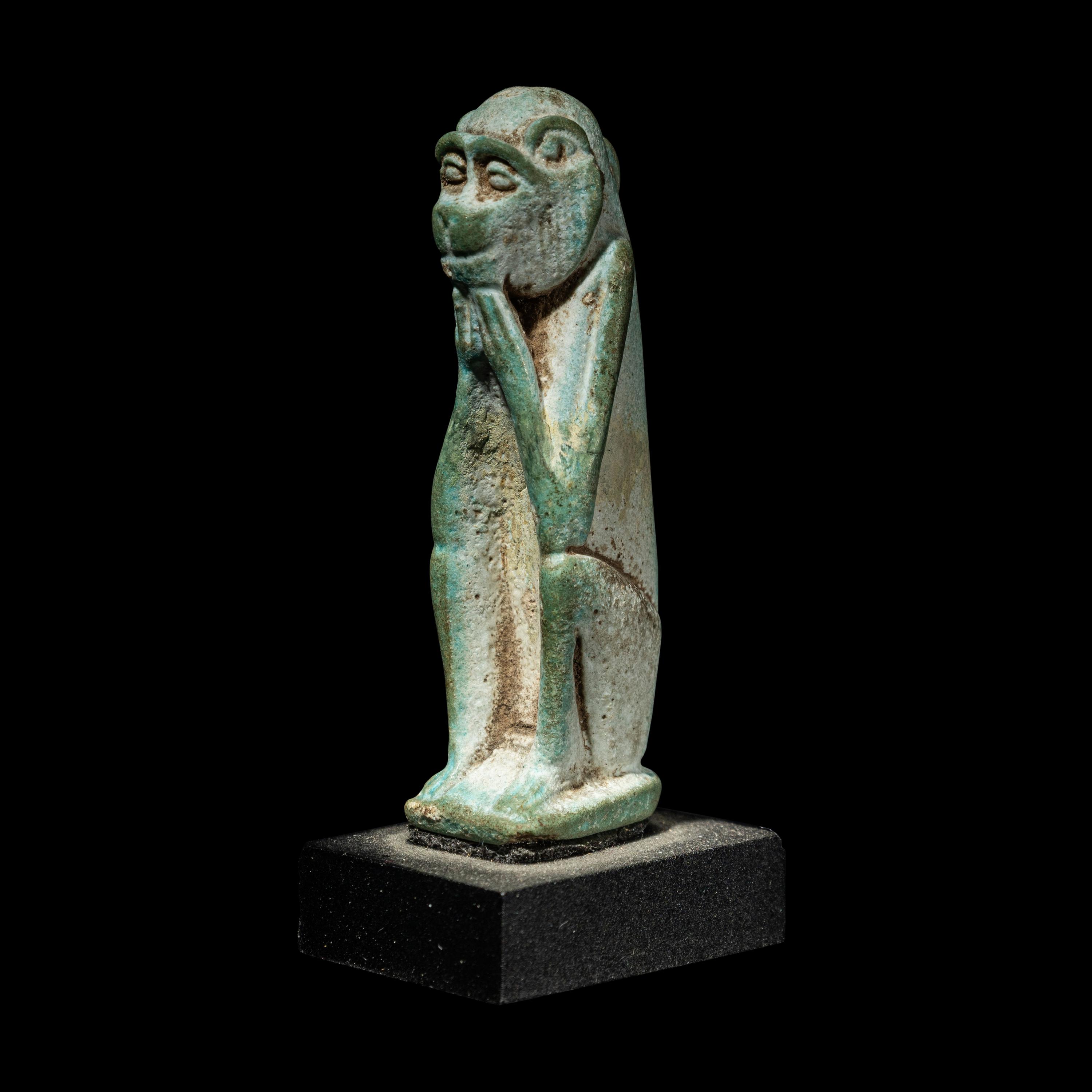 An Egyptian Faience Seated Monkey