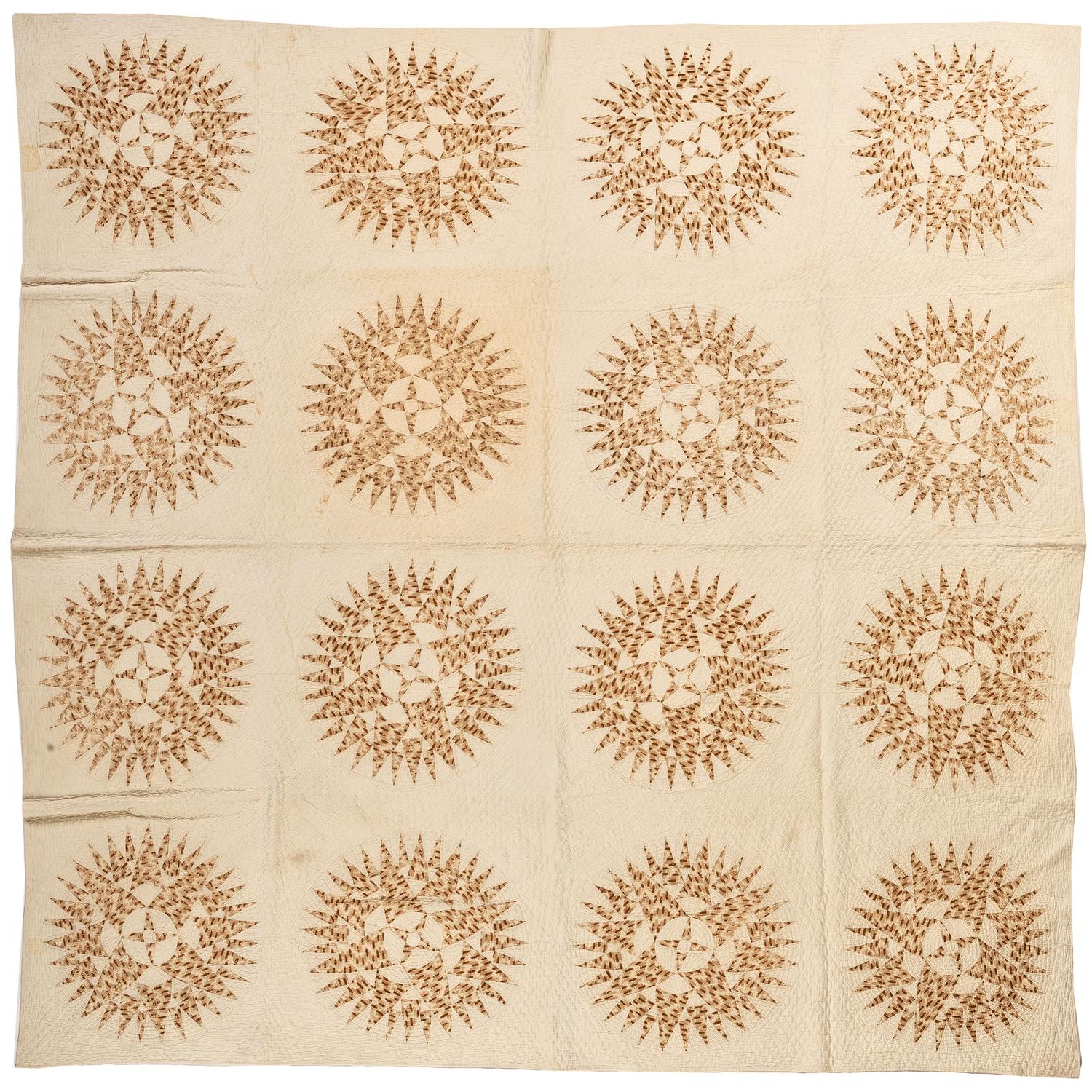 A Pieced Sunburst Quilt and a White Matelasse Coverlet