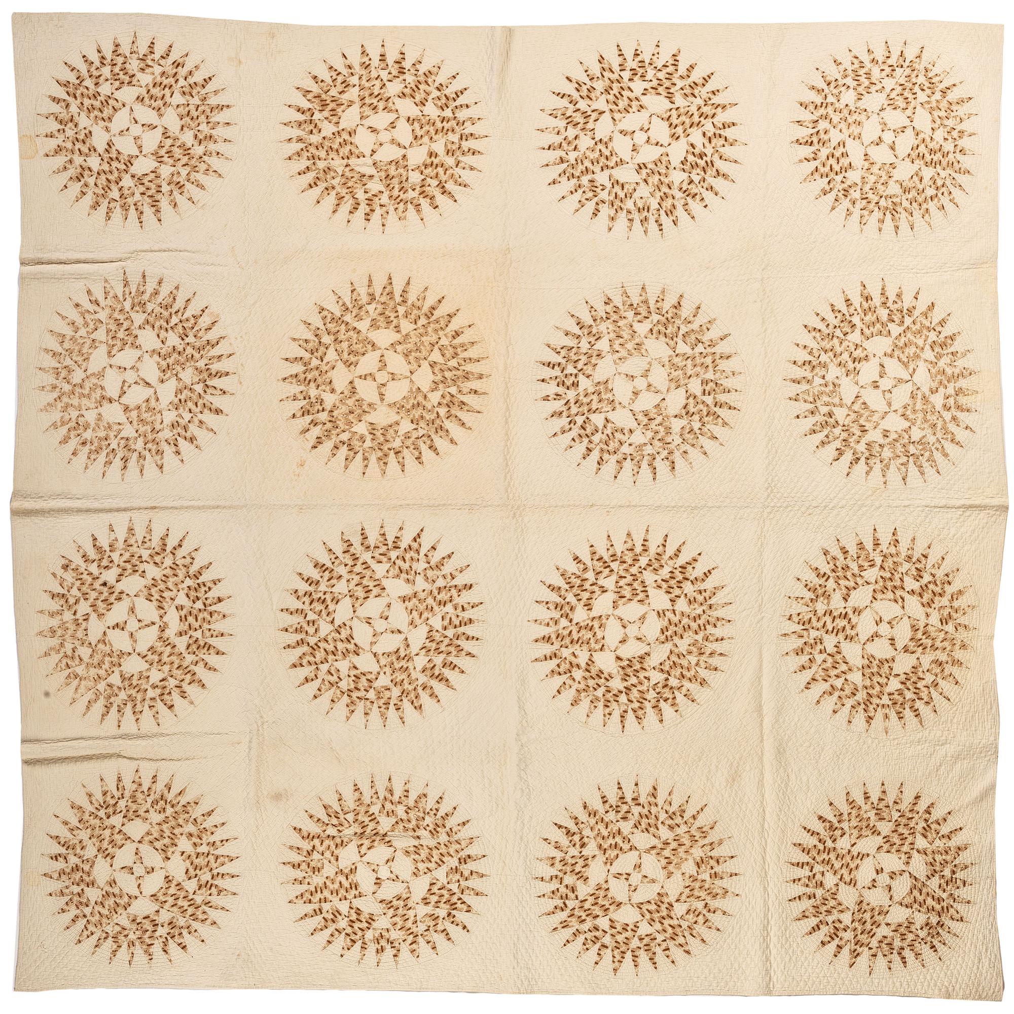 A Pieced Sunburst Quilt and a White Matelasse Coverlet