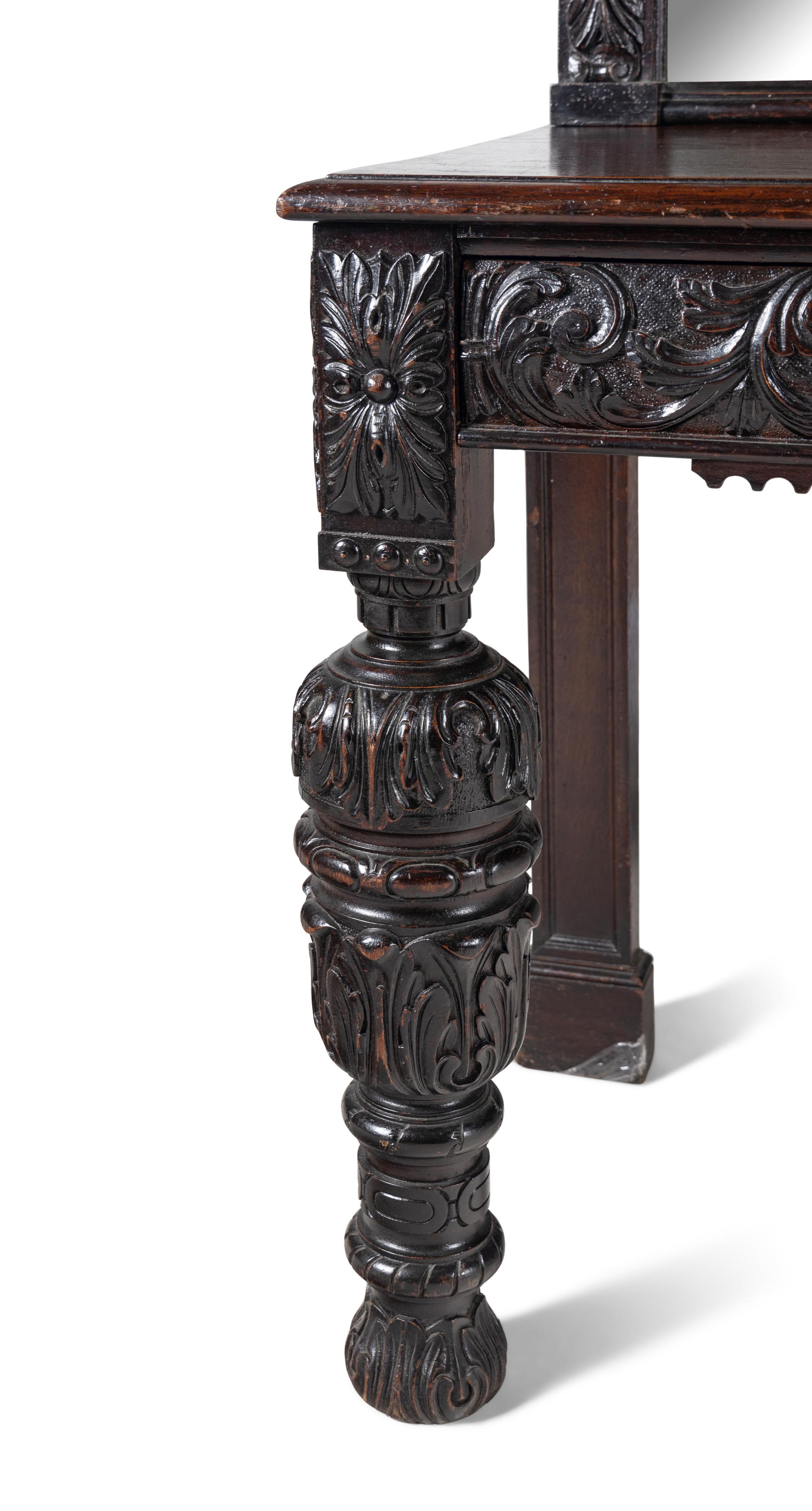 A Jacobean Style Carved Oak Sideboard and Mirror