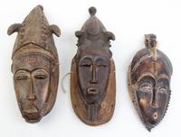A Group of Six Masks Height of largest 21 inches.