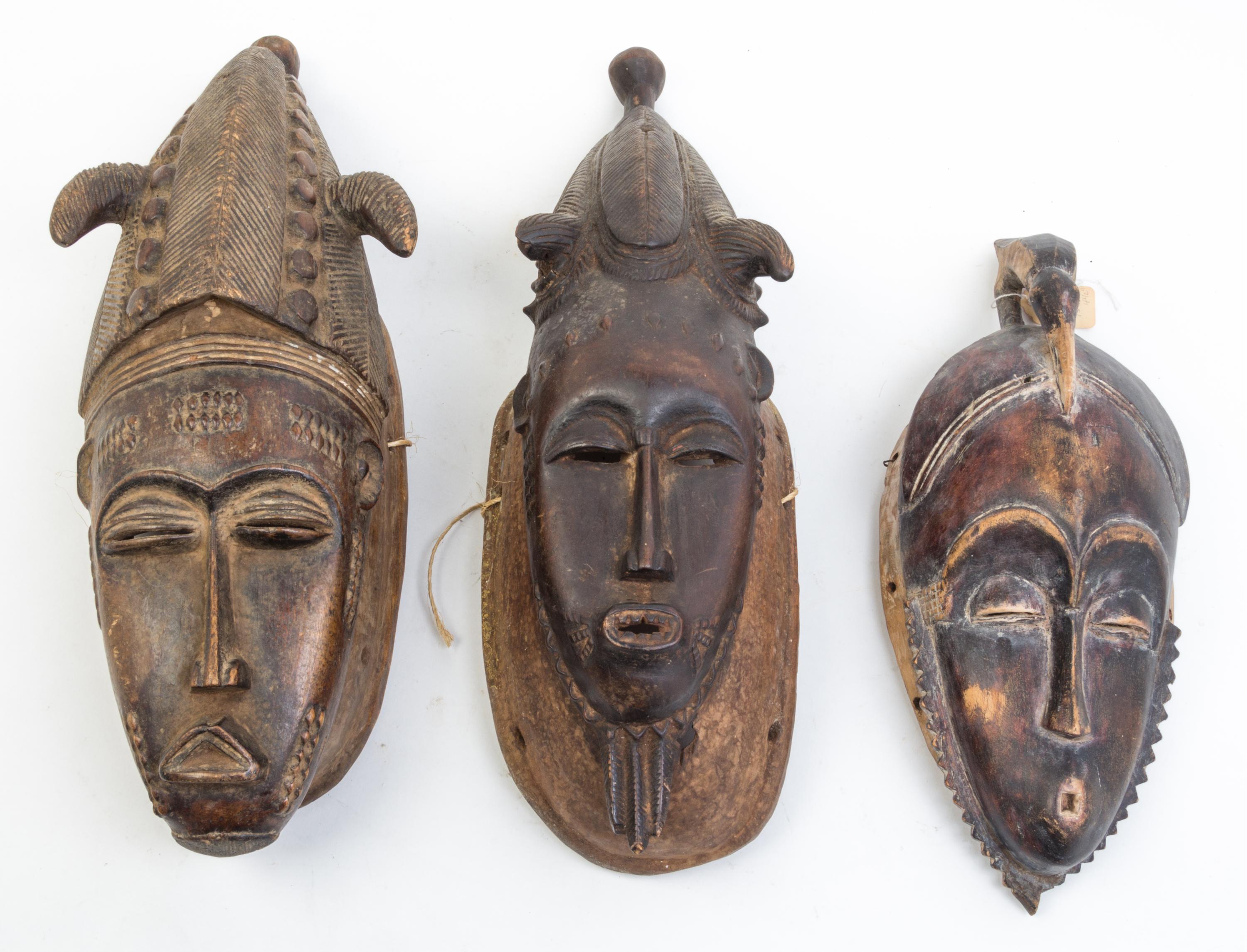 A Group of Six Masks Height of largest 21 inches.