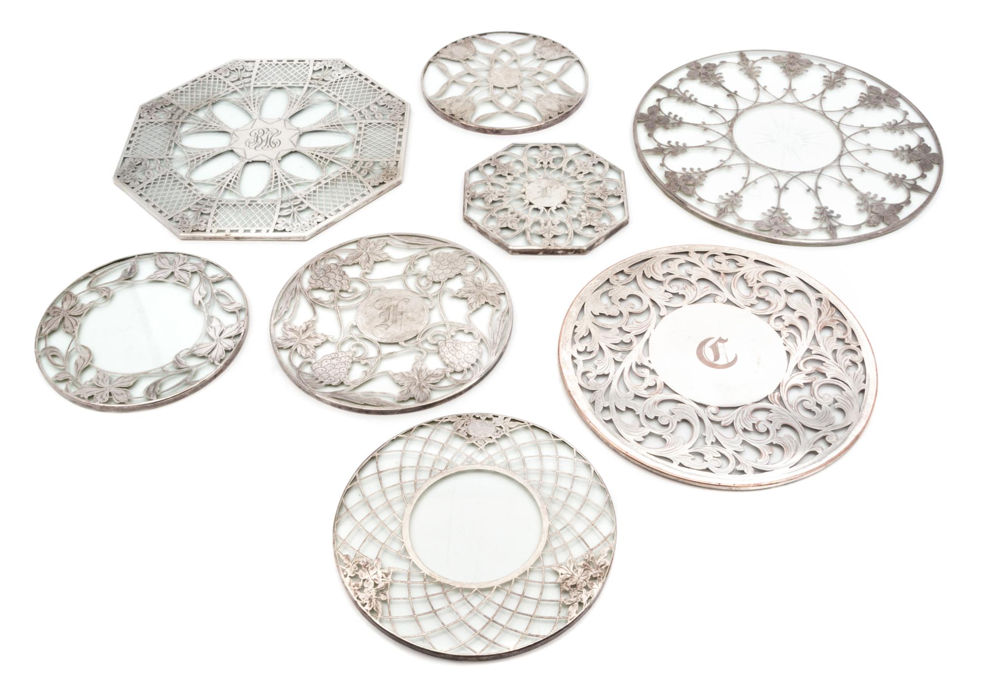 Eight Silver Overlay Glass Trivets Diameter of largest 12 inches.