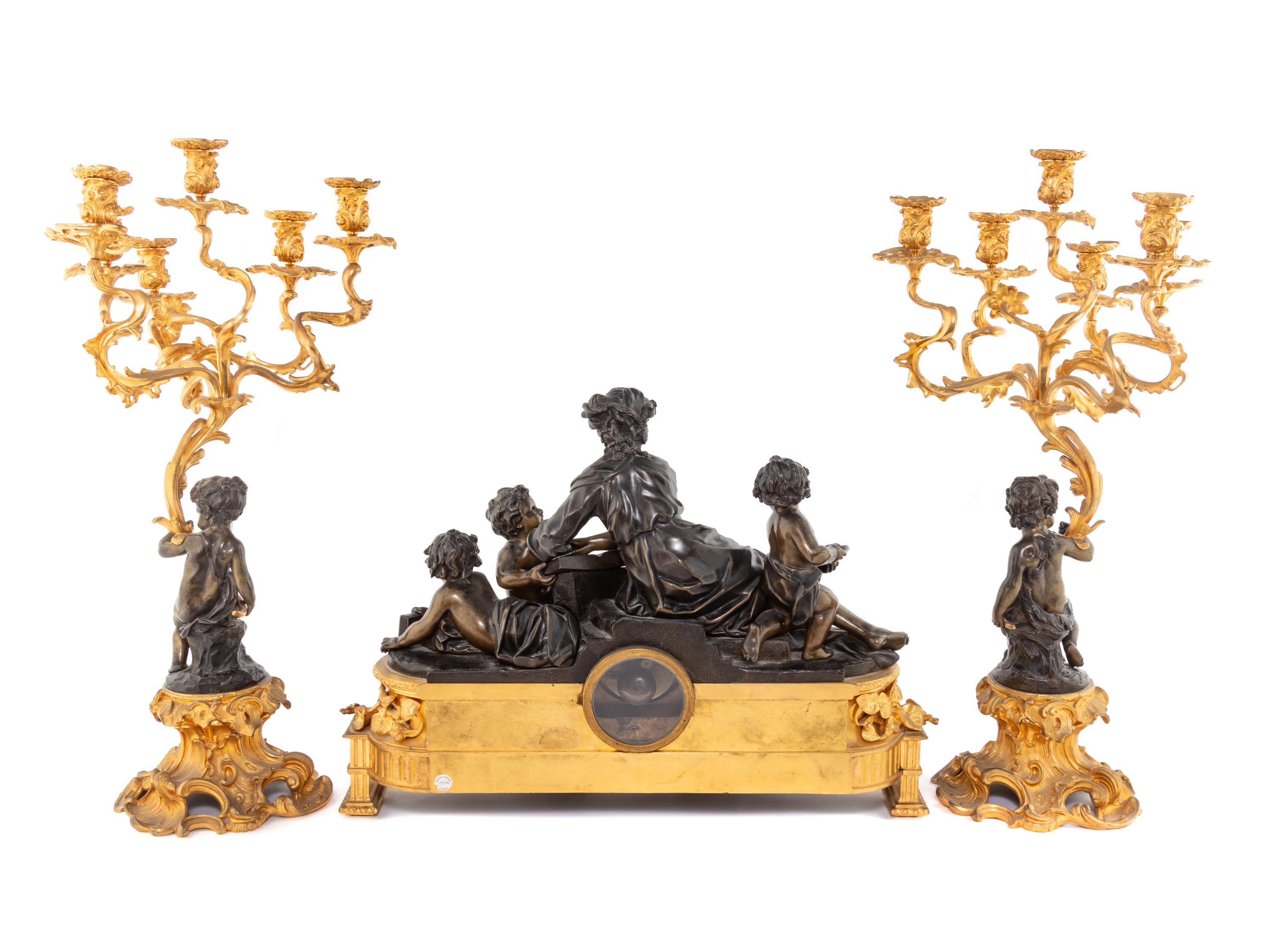 A French Gilt and Patinated Bronze Clock Garniture