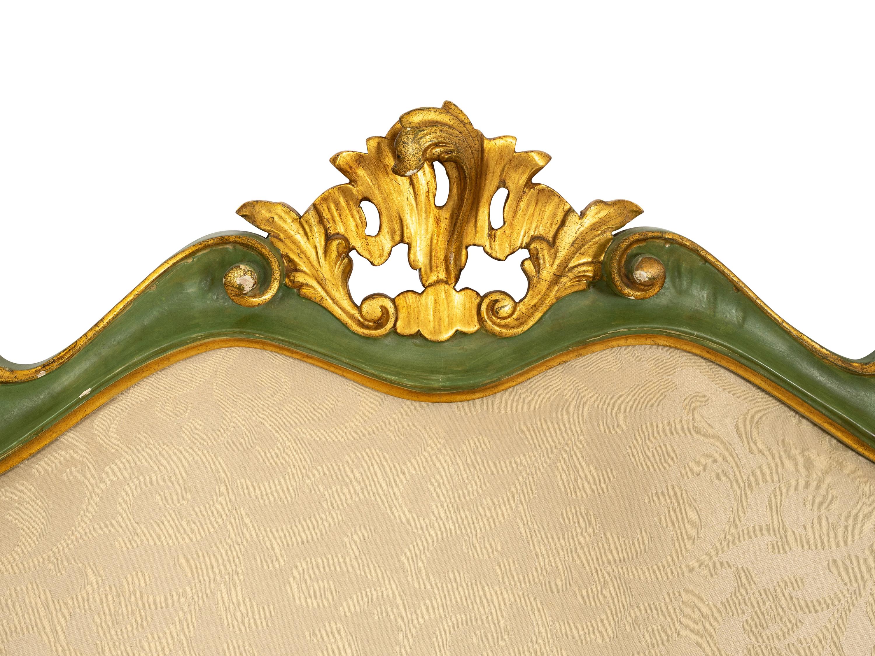 An Italian Green Painted and Parcel Gilt Headboard