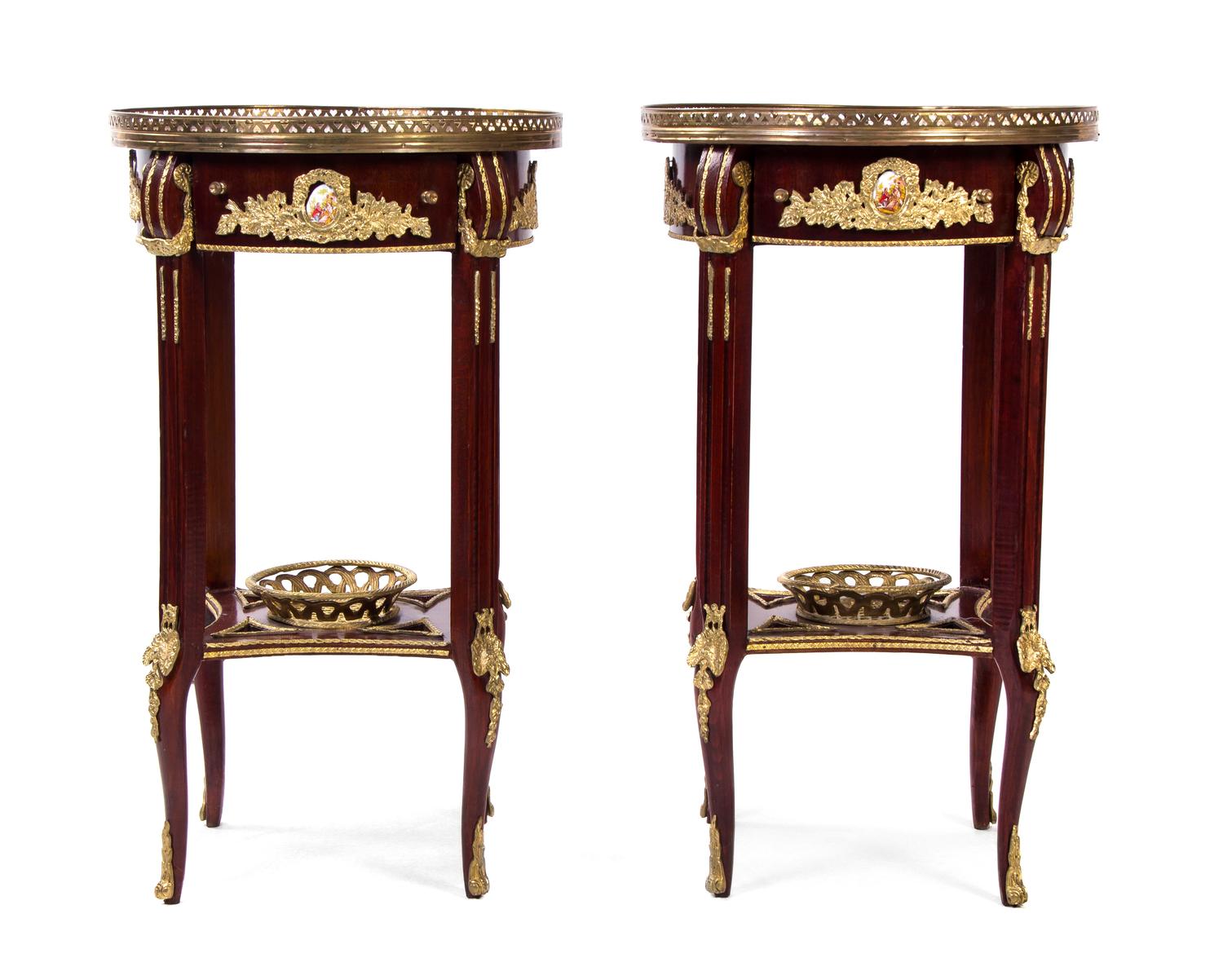 A Pair of Louis XVI Style Gilt Metal and Porcelain Mounted Marquetry Decorated Mahogany Side Tables, Height 31 x diameter 18 inches.