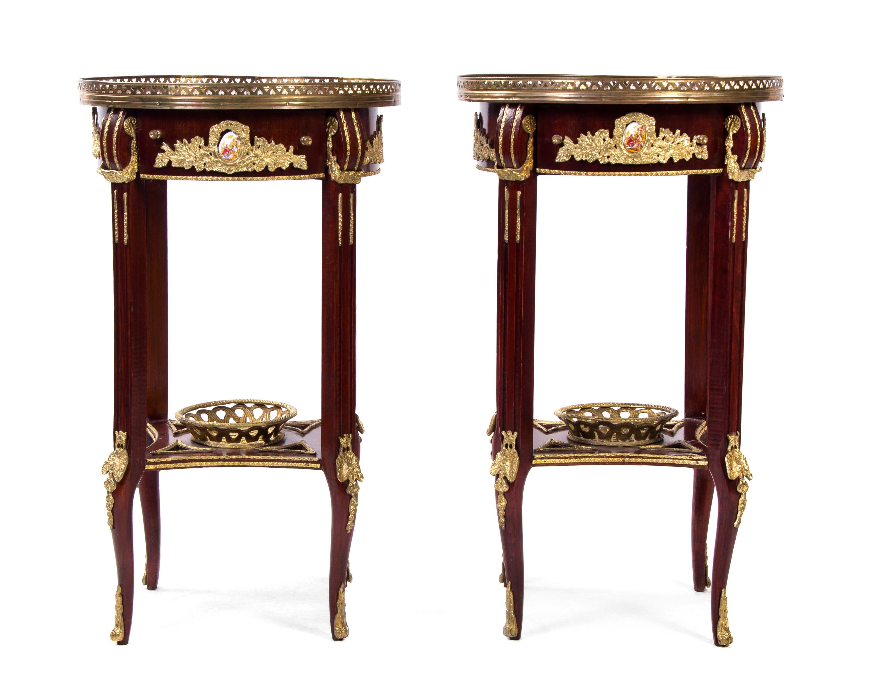 A Pair of Louis XVI Style Gilt Metal and Porcelain Mounted Marquetry Decorated Mahogany Side Tables, Height 31 x diameter 18 inches.