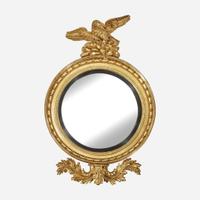 A Large Regency Parcel-Ebonized Giltwood Convex Girandole Mirror Early 19th century