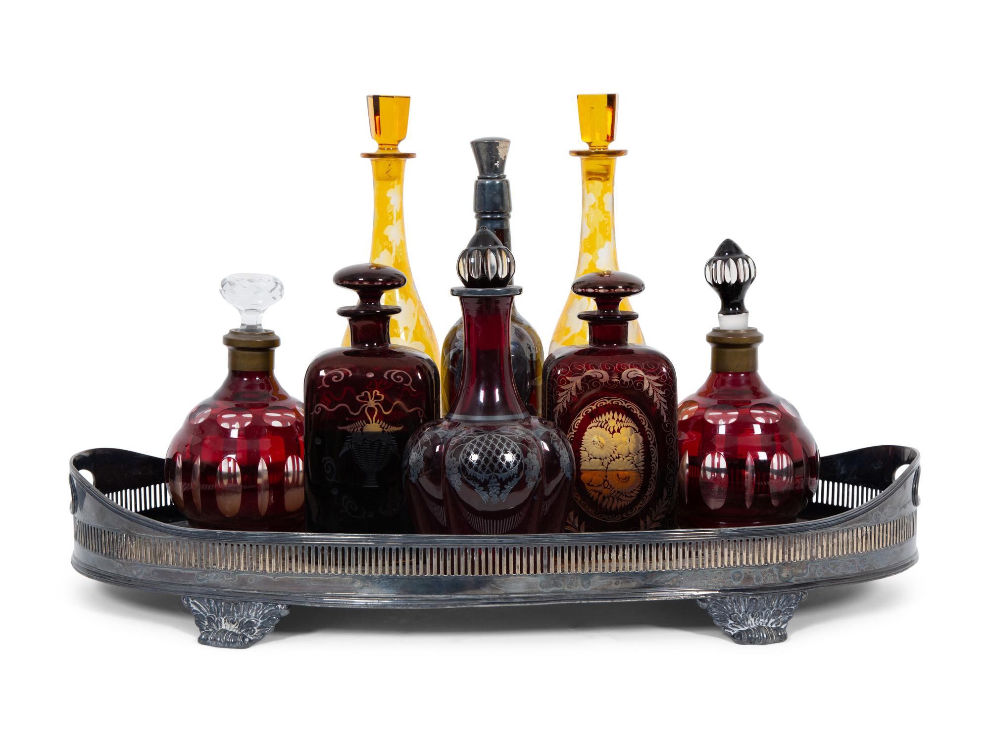 Eight Colored Glass Decanters and a Silver-Plate Galleried Serving Tray