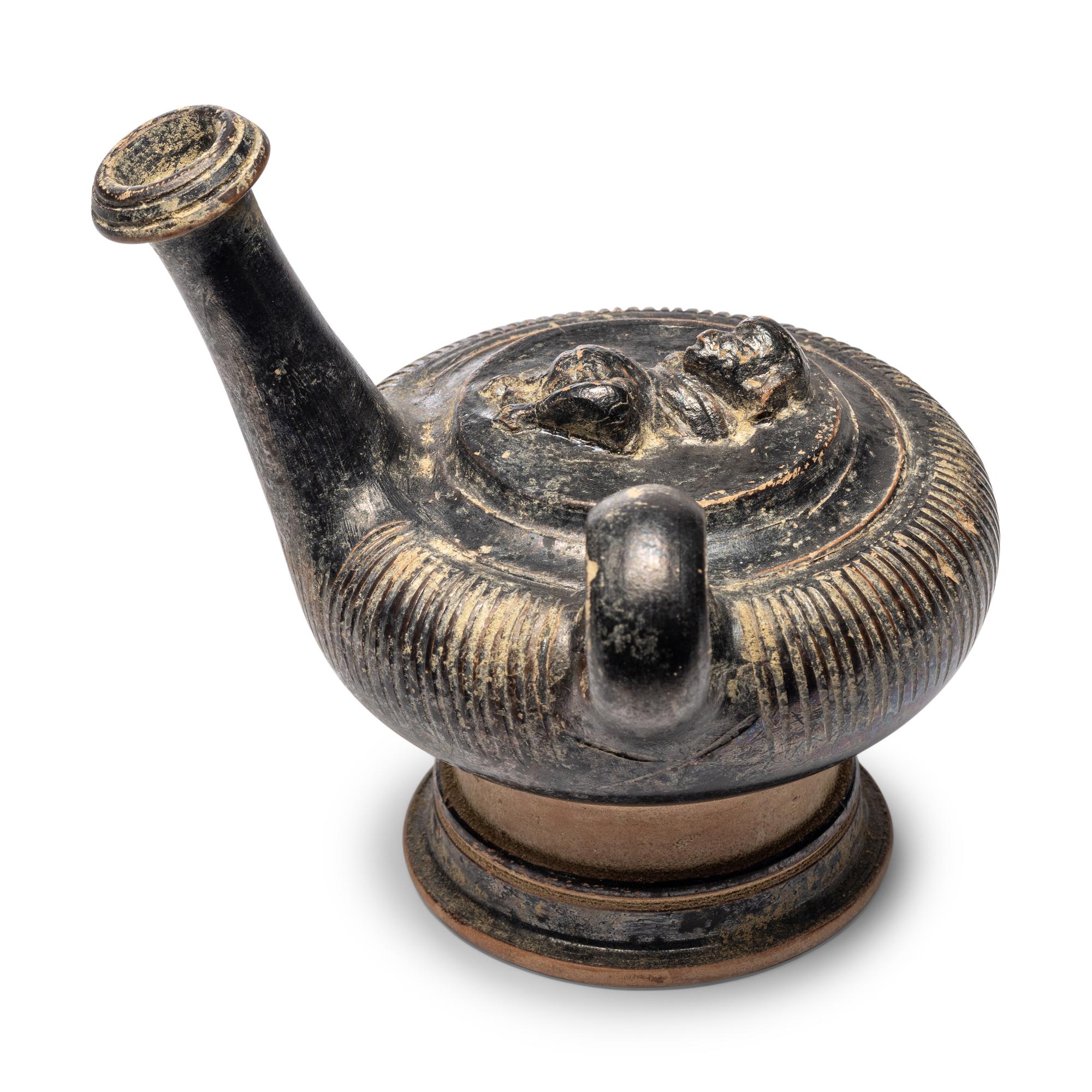 A Campanian Black-Glazed Guttus with a Grotesque