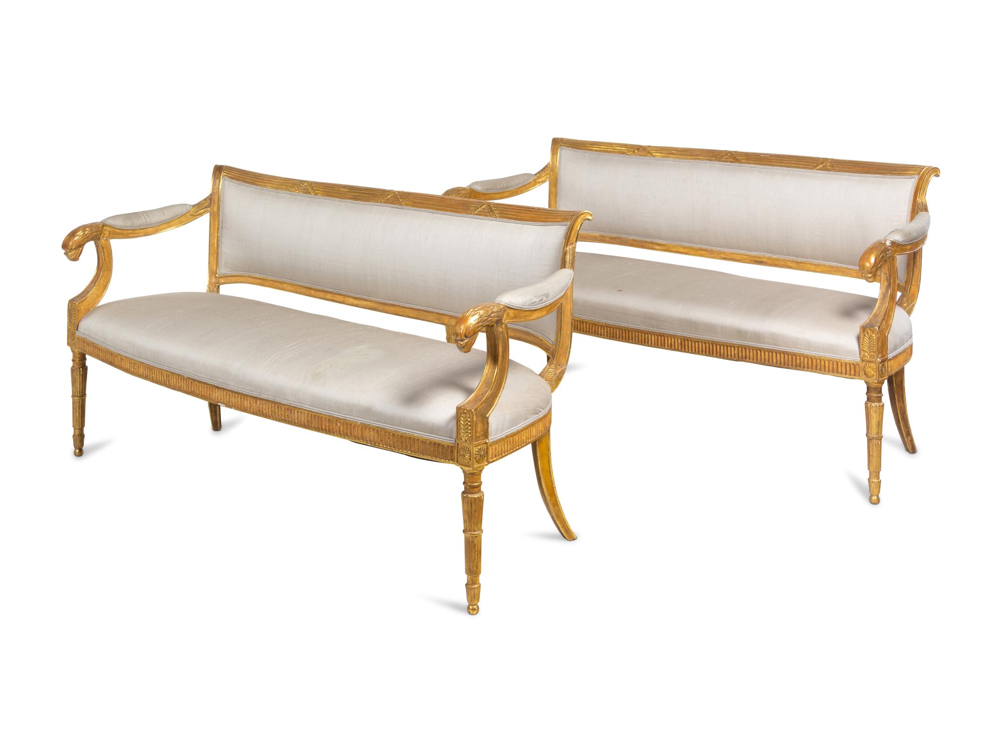 A Pair of Northern Italian Giltwood Sofas with Griffin Supports