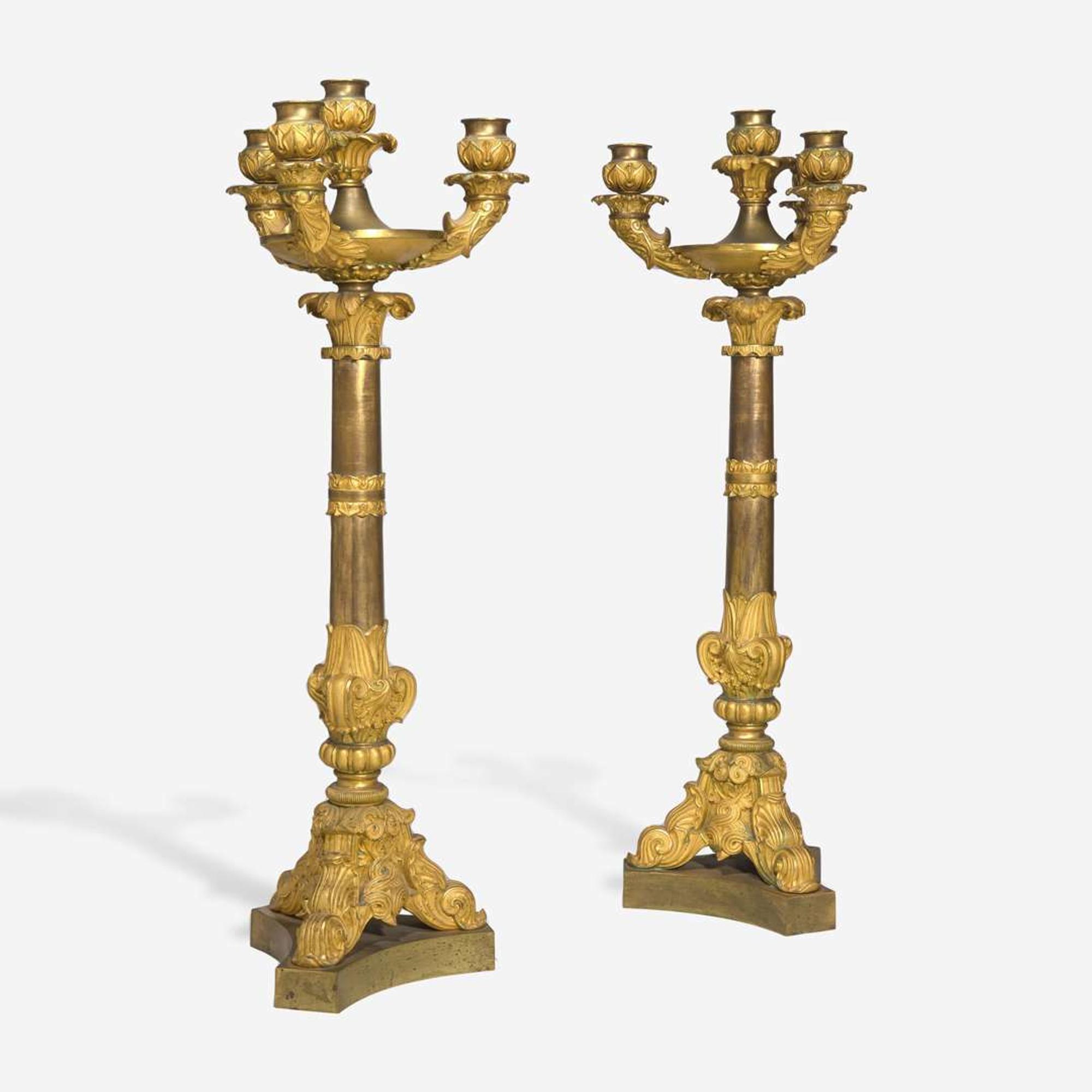 A pair of large French Louis Philippe ormolu candlesticks circa 1830-1840