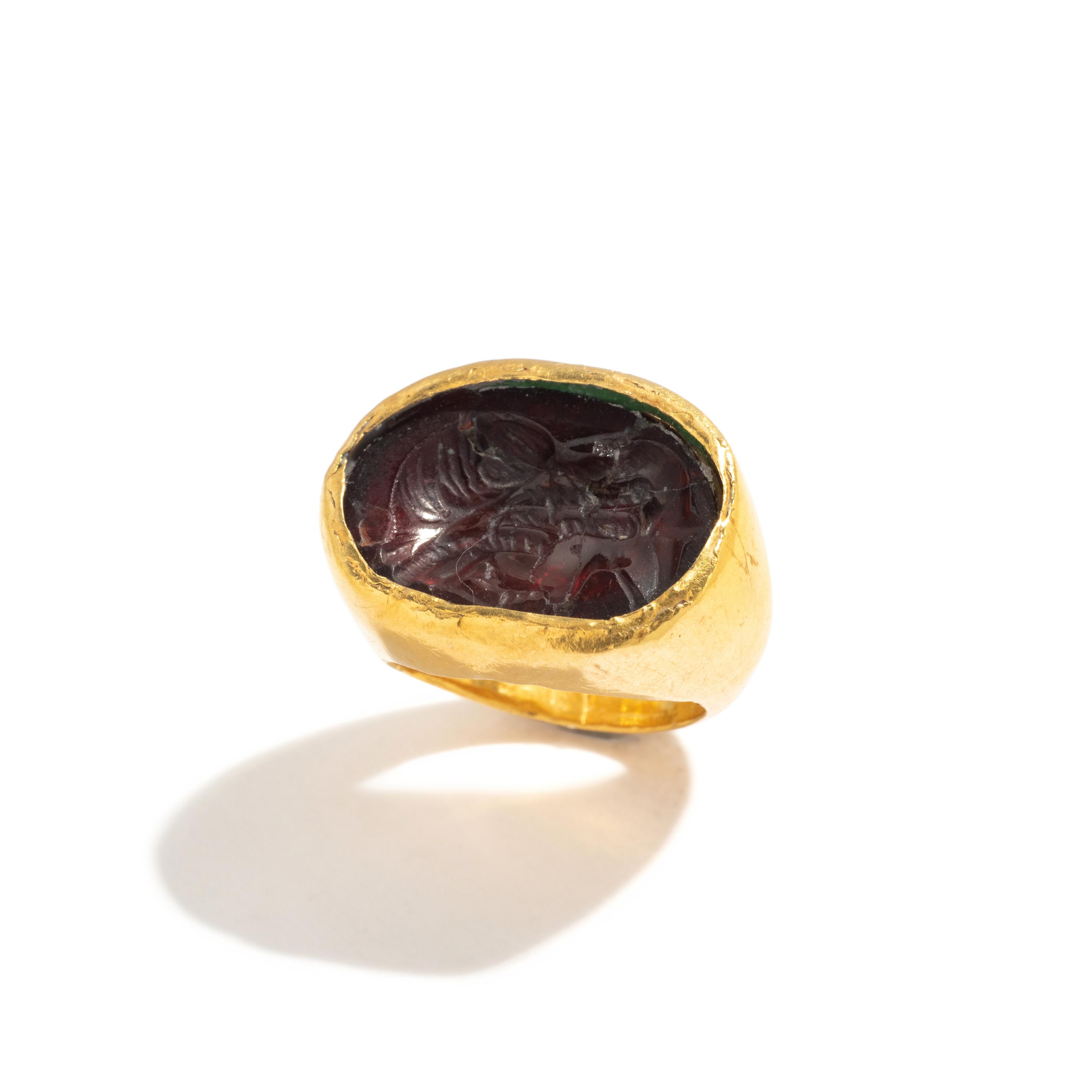 A Greek Gold and Garnet Finger Ring with the Goddess Isis