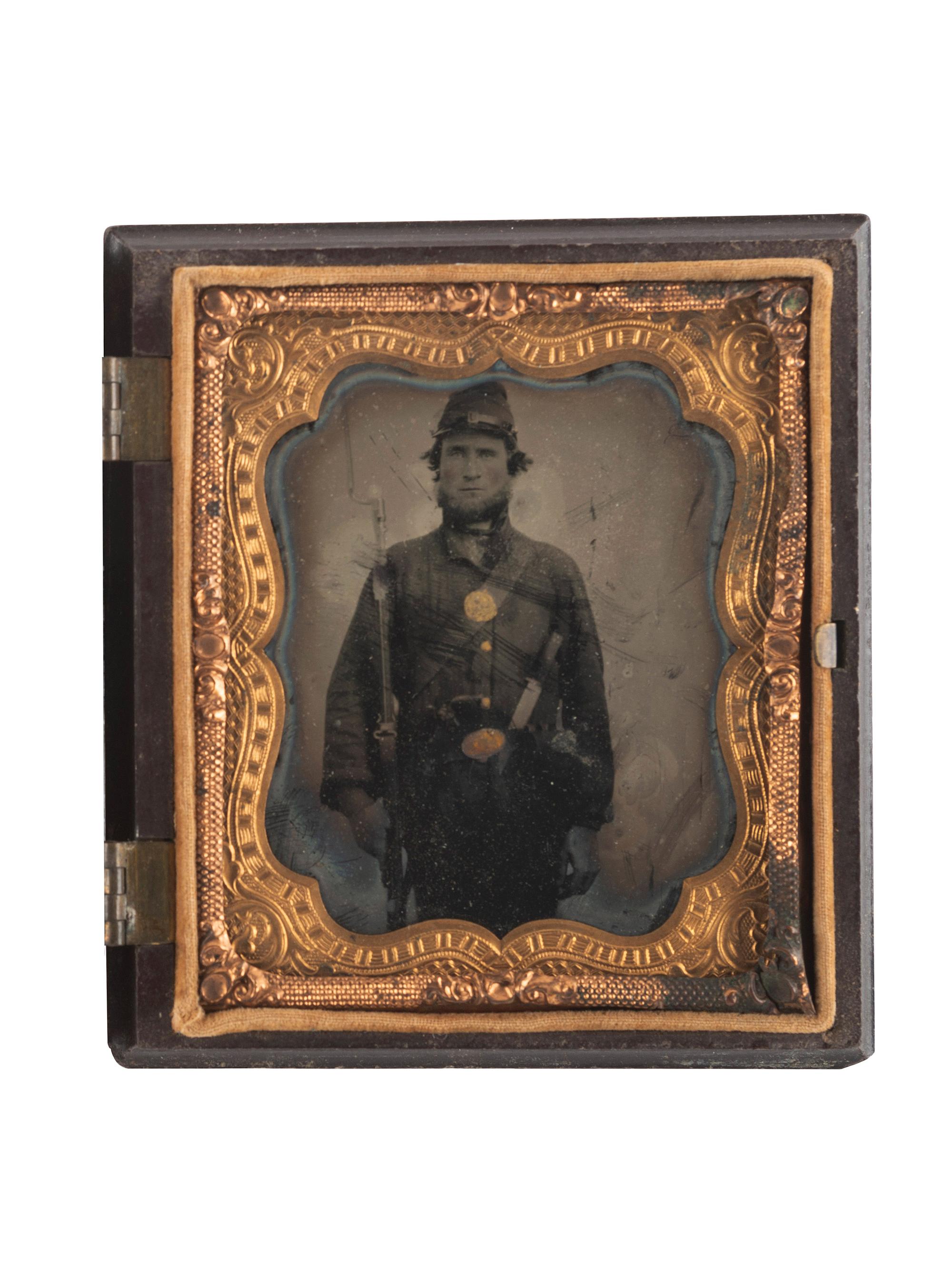 [CIVIL WAR]. Sixth plate ruby ambrotype of heavily armed Union soldier.