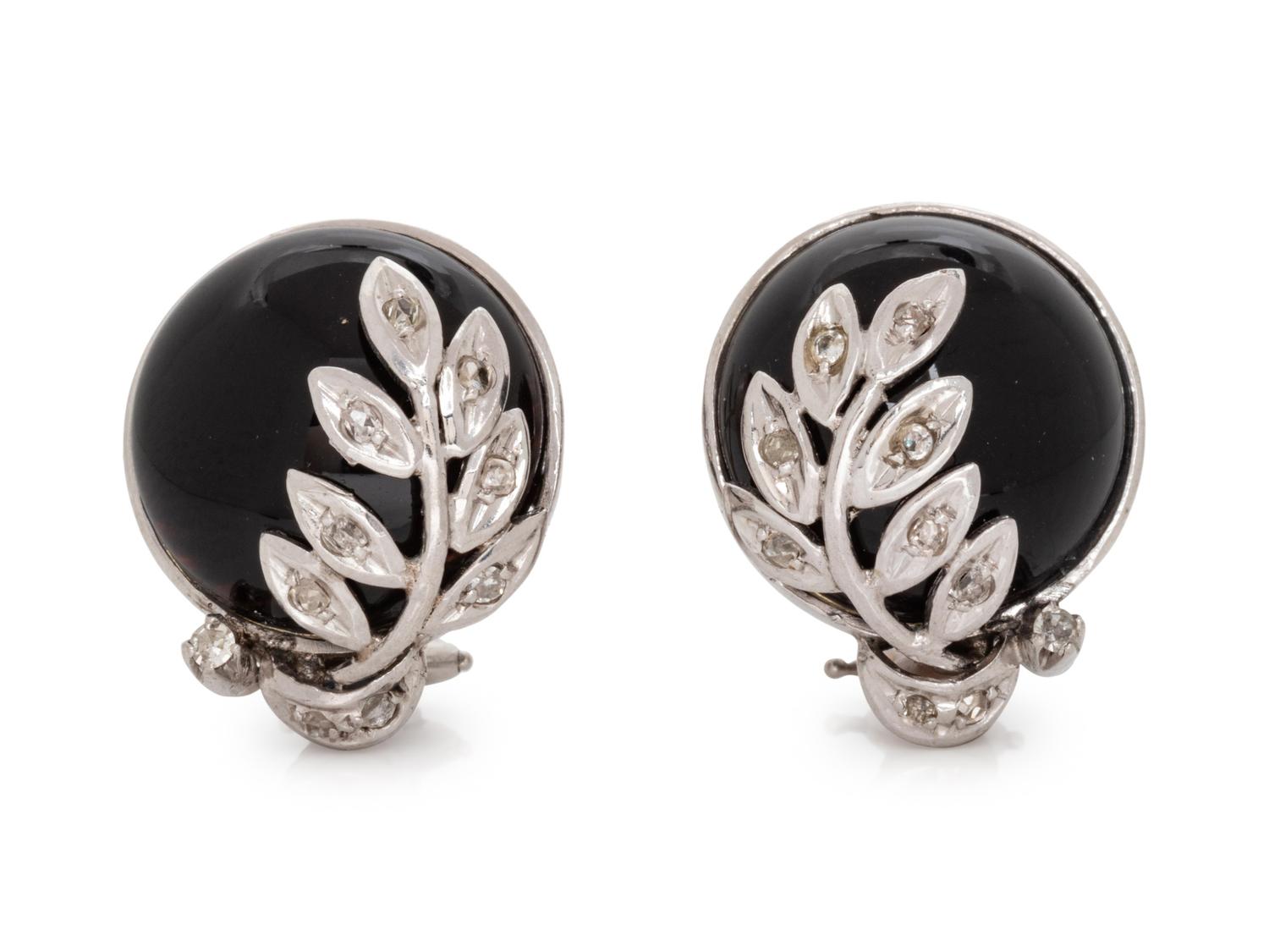 A Pair of 14 Karat White Gold, Onyx and Diamond Earclips,