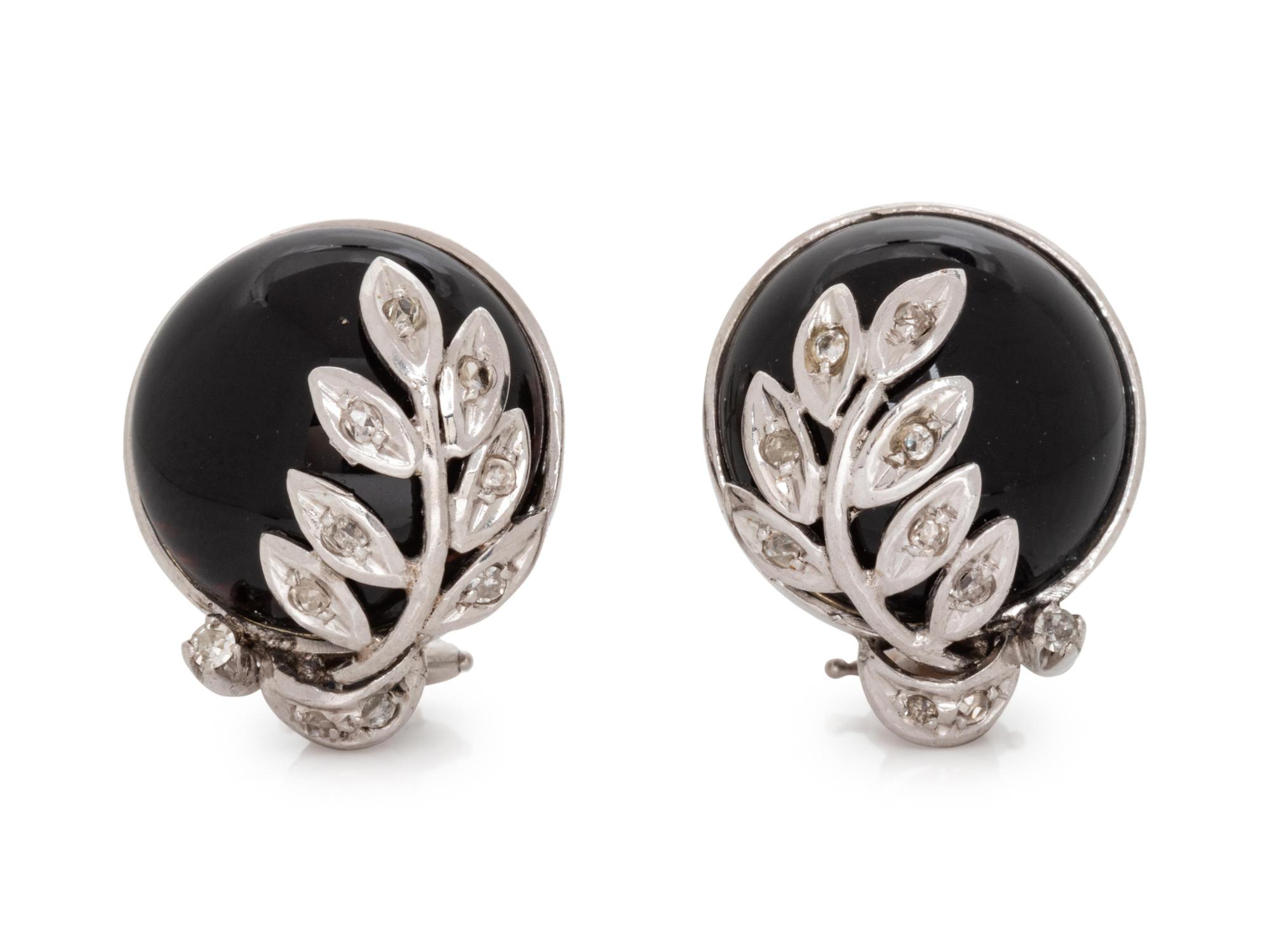 A Pair of 14 Karat White Gold, Onyx and Diamond Earclips,