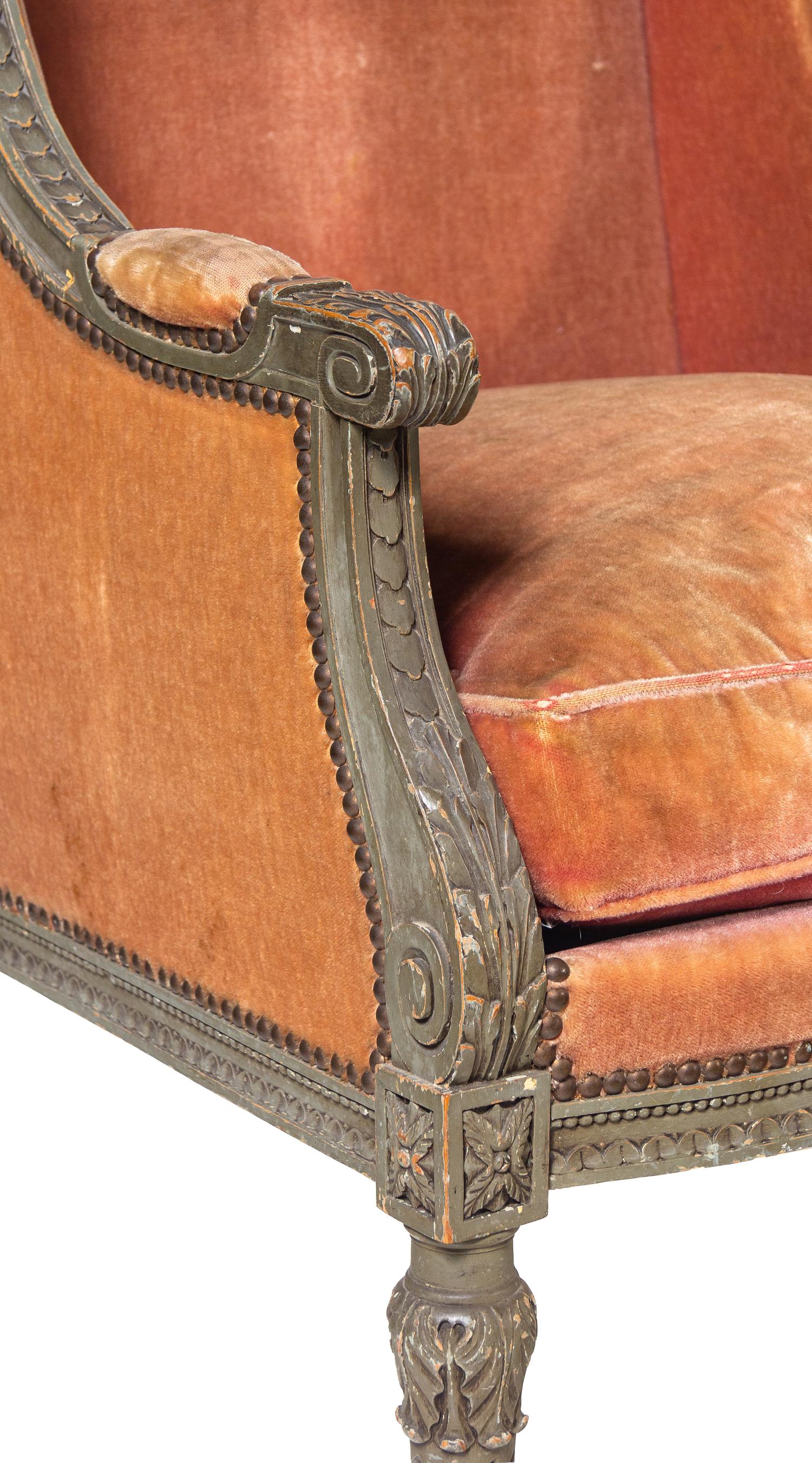 A Pair of Louis XVI Carved and Painted Walnut Bergères à L'Oreilles