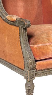 A Pair of Louis XVI Carved and Painted Walnut Bergères à L'Oreilles