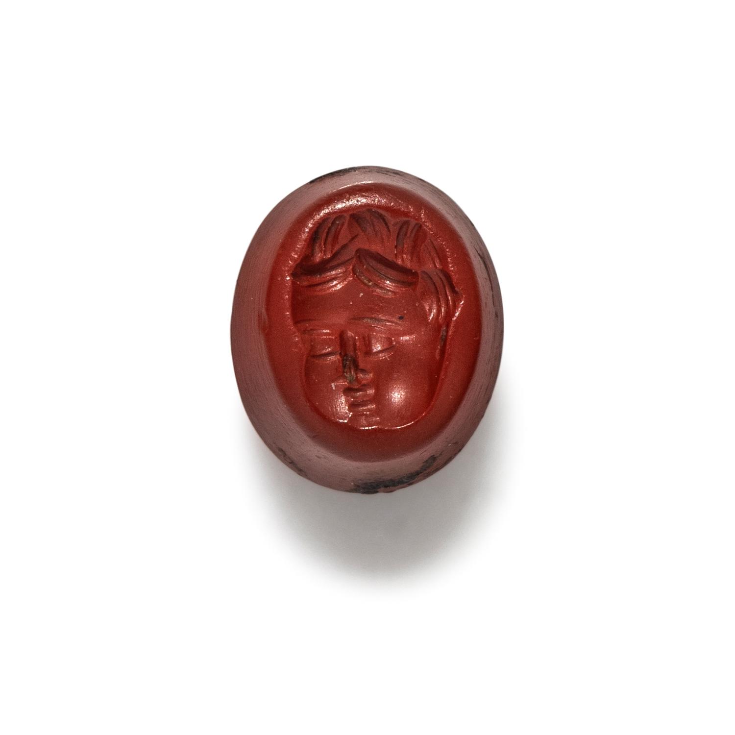 A Roman Red Jasper Ring Stone with the Head of a Baby