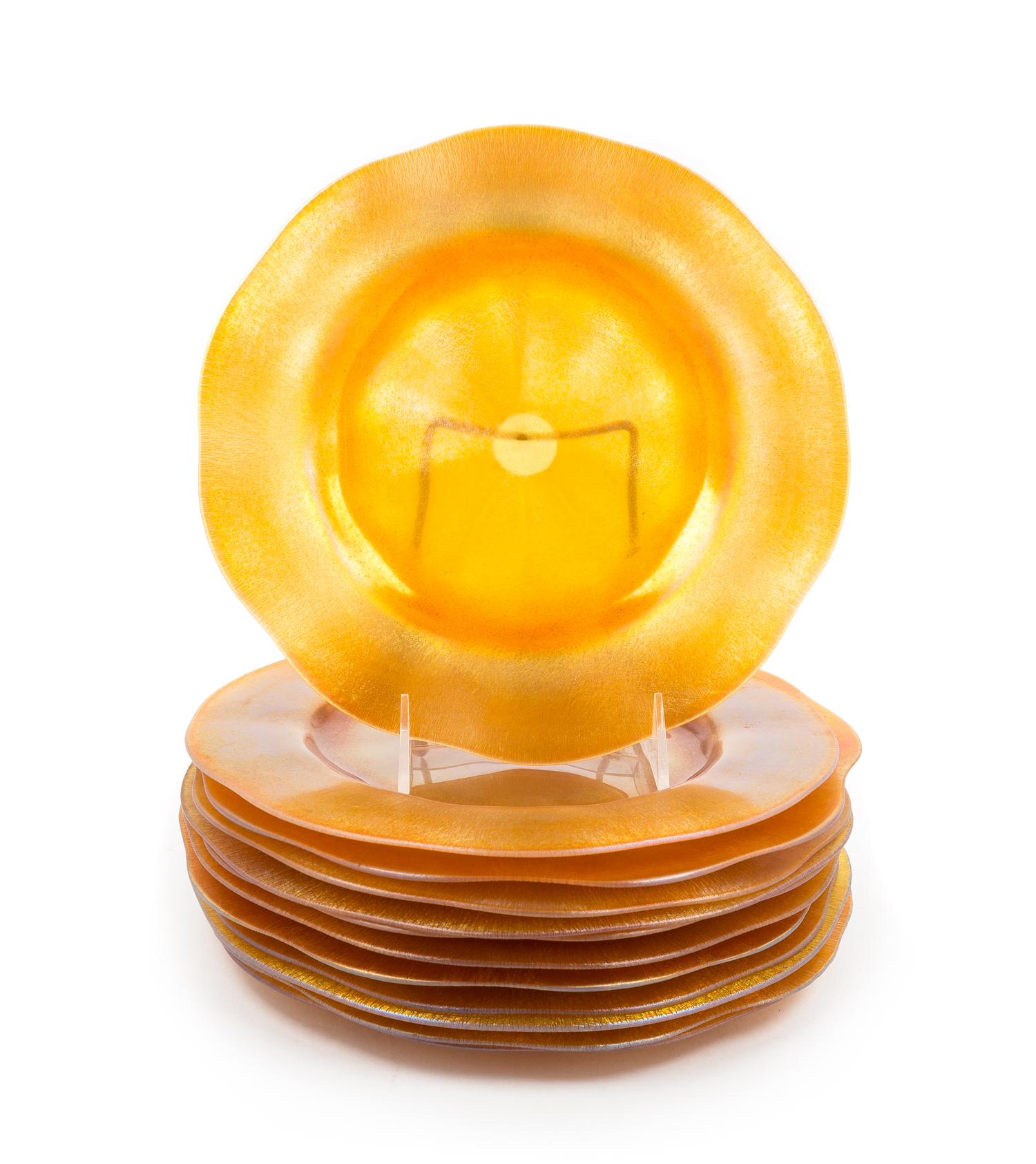 Steuben, EARLY 20TH CENTURY, a set of twelve plates or chargers, of iridescent gold