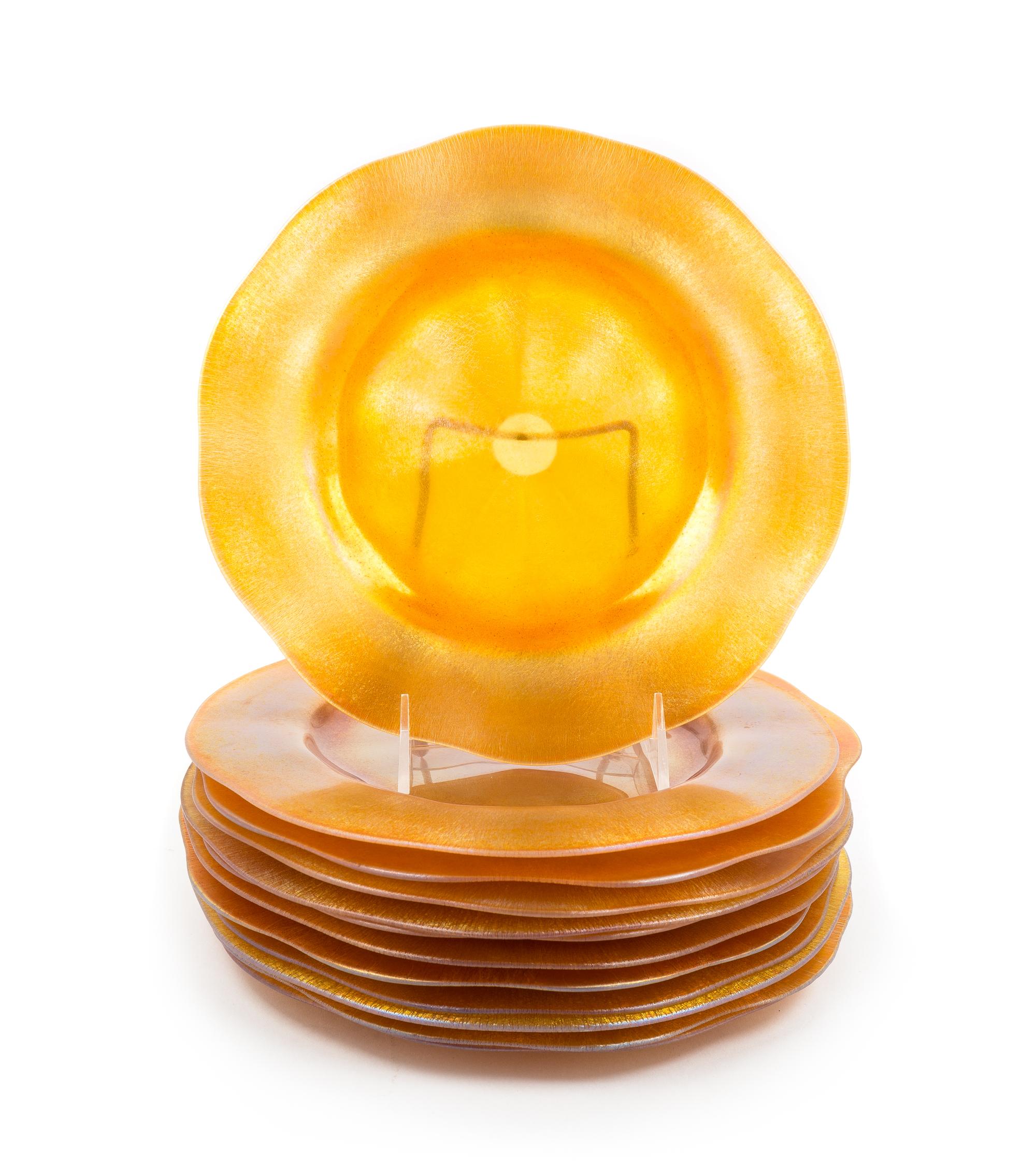 Steuben, EARLY 20TH CENTURY, a set of twelve plates or chargers, of iridescent gold