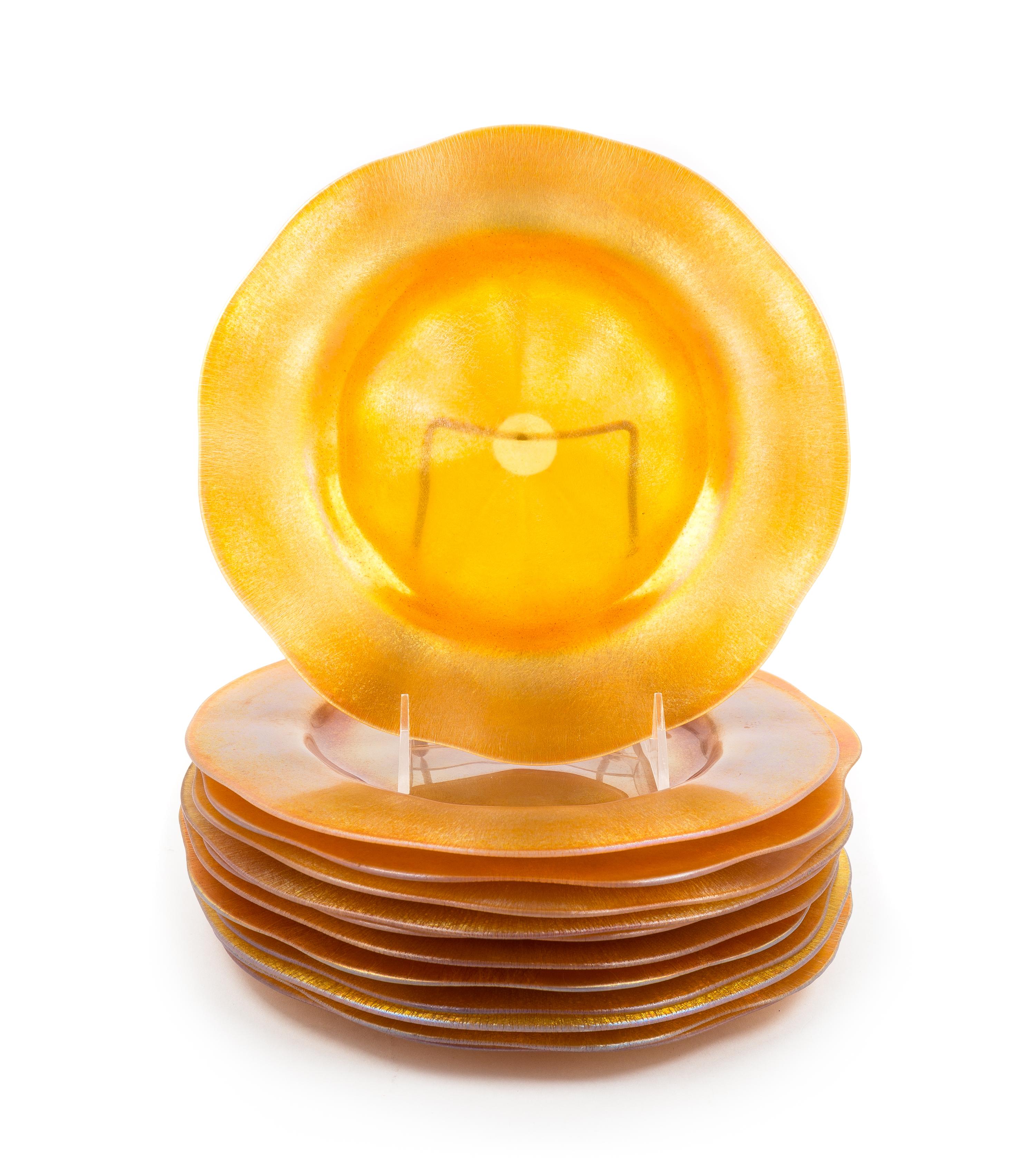 Steuben, EARLY 20TH CENTURY, a set of twelve plates or chargers, of iridescent gold