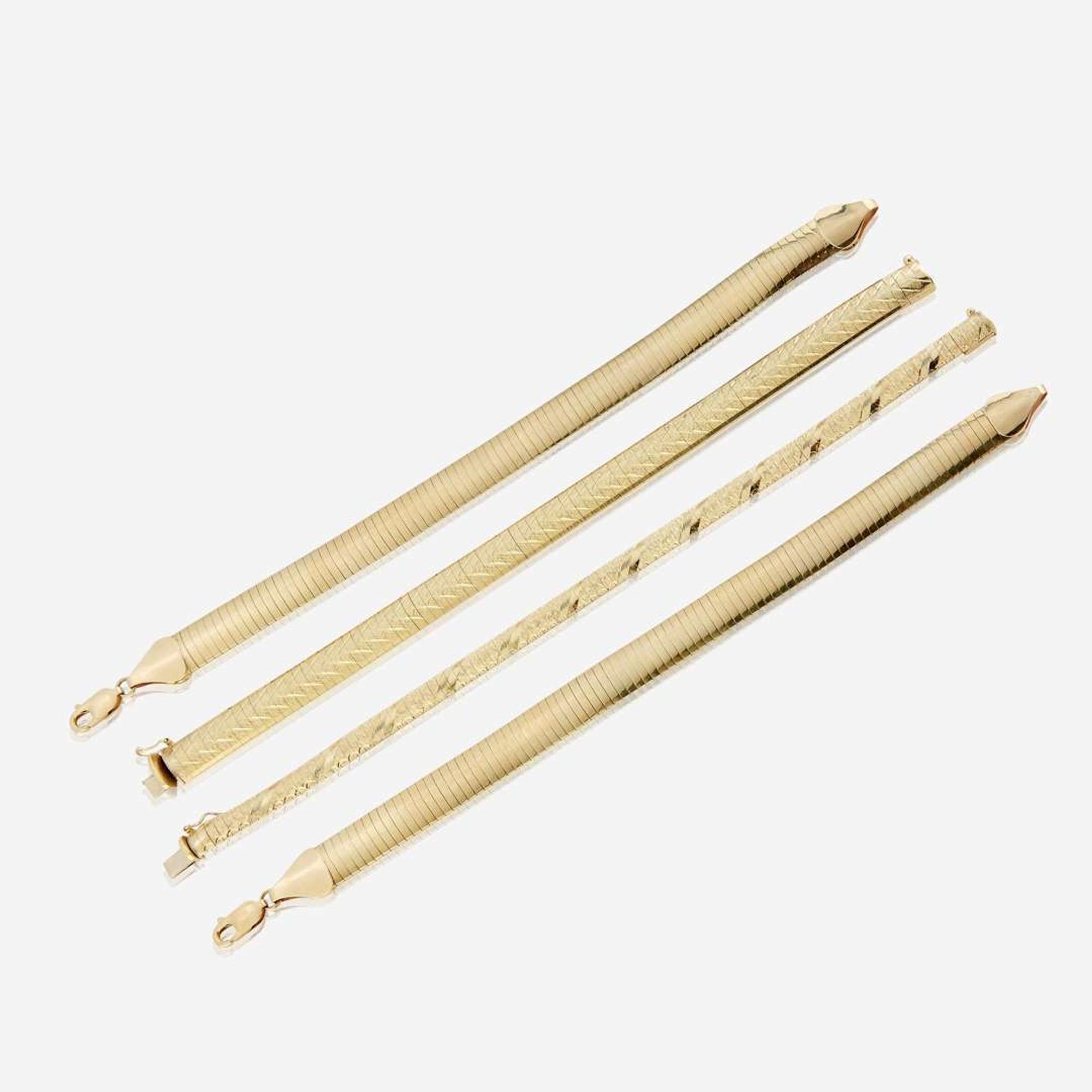 A collection of four fourteen karat gold bracelets