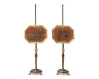 A pair of Regency ebonized and parcel-gilt firescreens with painted velvet theorem panels, circa 1820