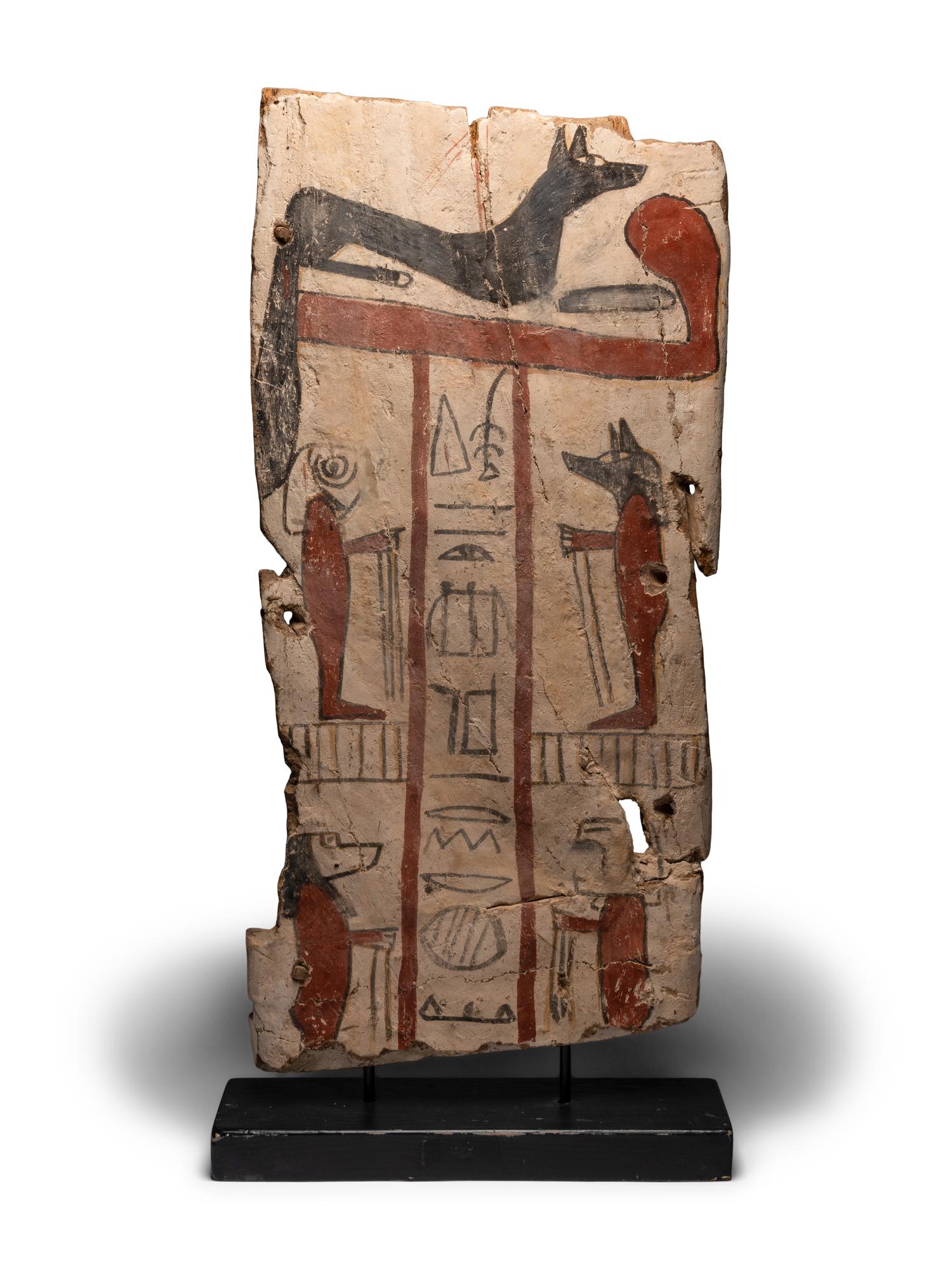 An Egyptian Painted Wood Sarcophagus Panel with Anubis