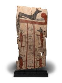 An Egyptian Painted Wood Sarcophagus Panel with Anubis