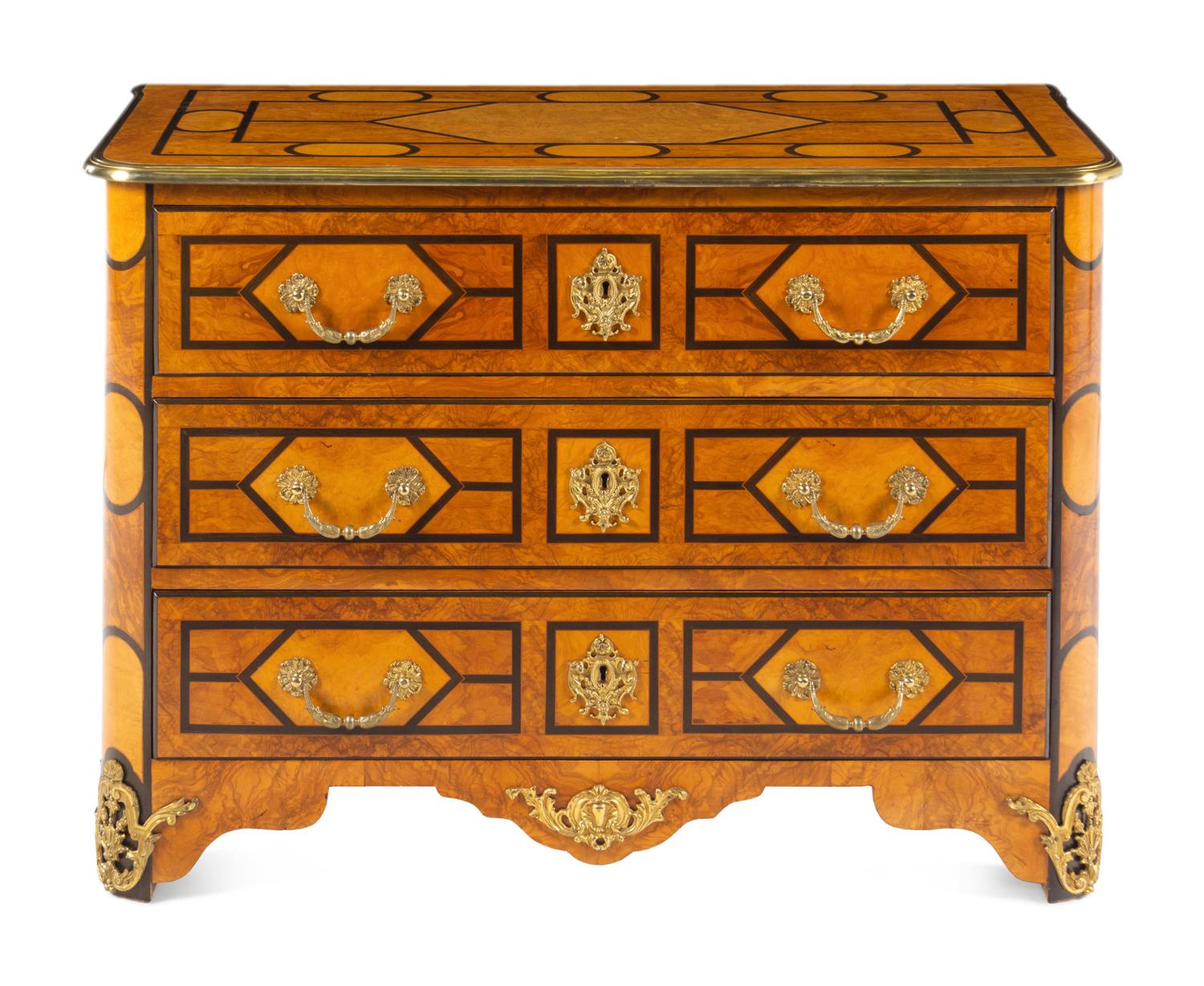 A Régence Style Gilt Metal Mounted Burl Walnut Chest of Drawers