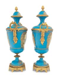A Pair of Sèvres Style Gilt Bronze Mounted Porcelain Urns