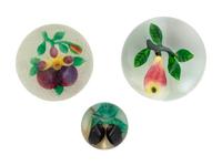 A Two Plums Glass Paperweight, a Chinese Pansy and Bud on Latticino Basket Glass Paperweight and a Pear Glass Paperweight