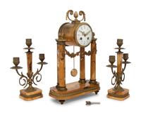 A French Gilt Metal and Siena Marble Three-Piece Clock Garniture