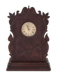 A Carved Walnut Folk Art Clock Hutch