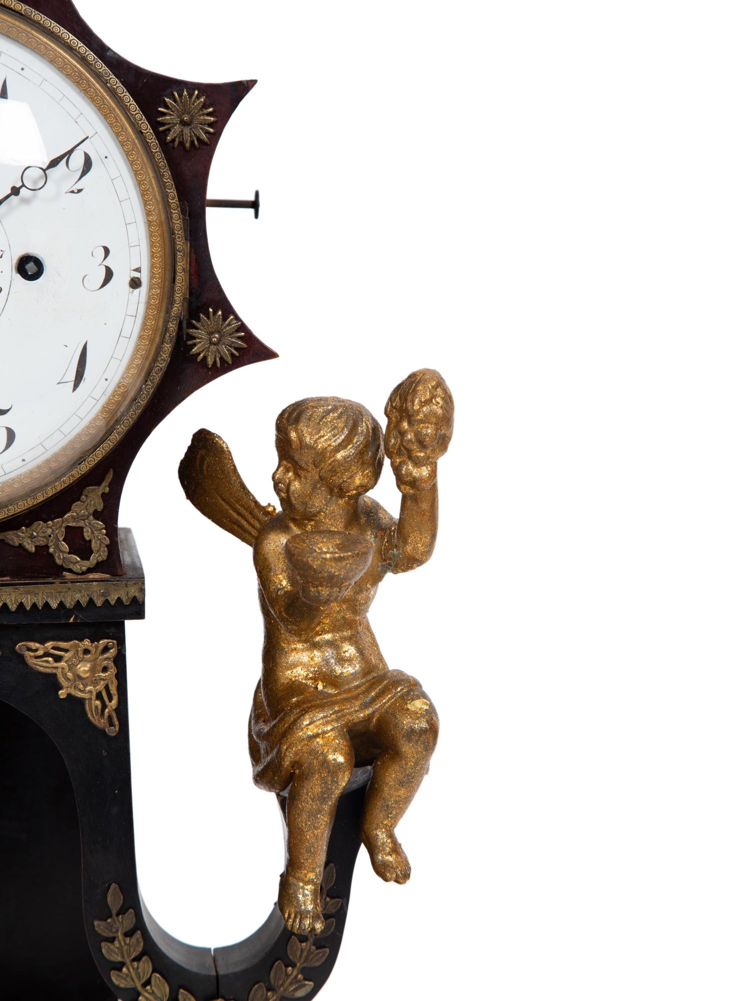 An Austrian Ebonized and Burlwood Mantel Clock with Gilt Metal and Giltwood Mounts