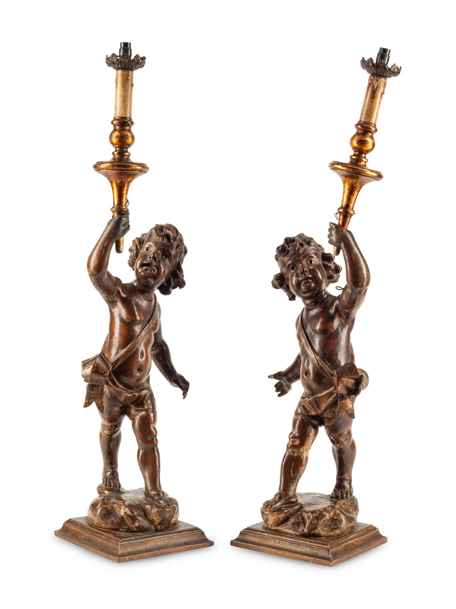 A Pair of Continental Carved Walnut Figures of Putti