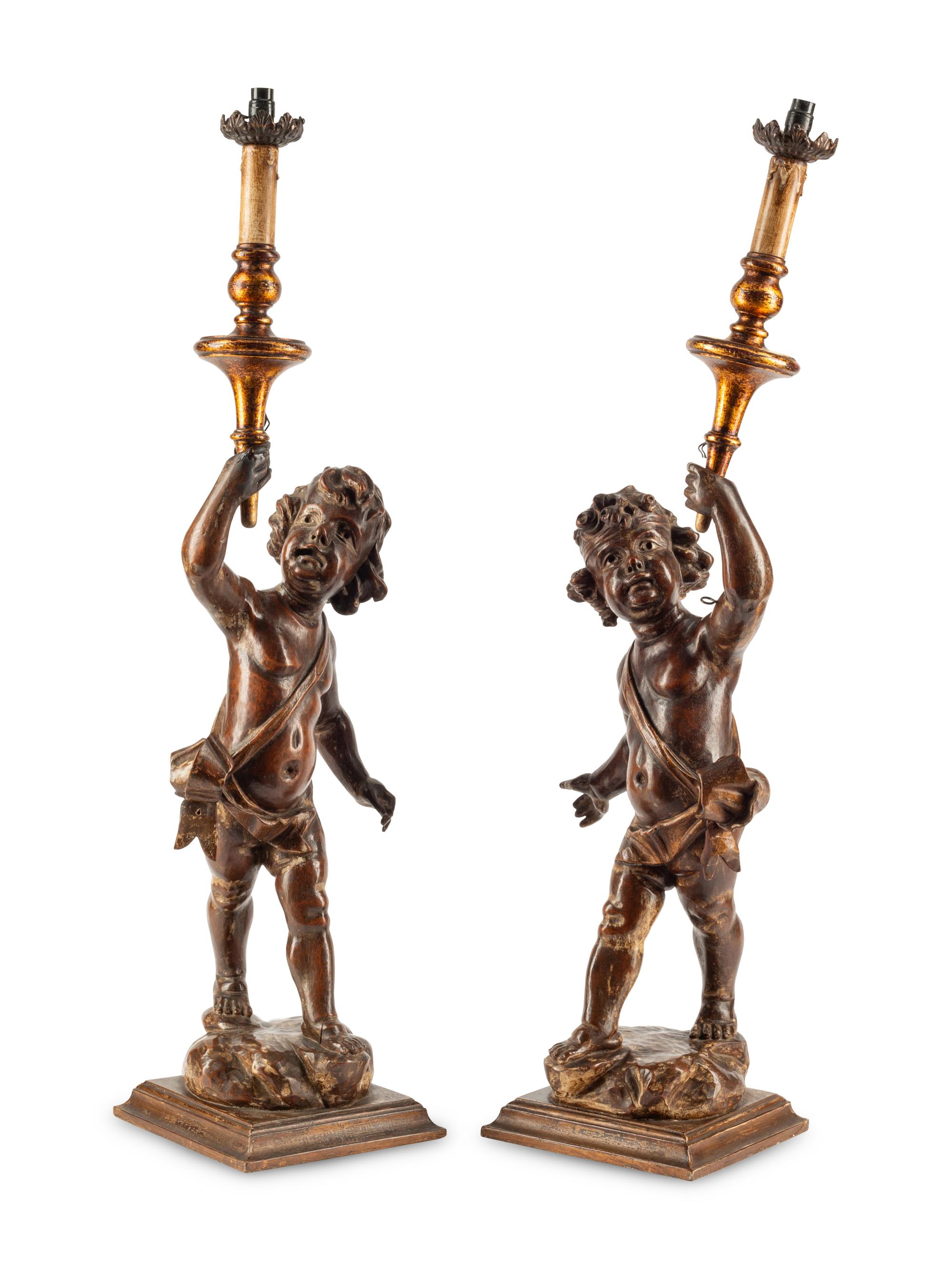 A Pair of Continental Carved Walnut Figures of Putti