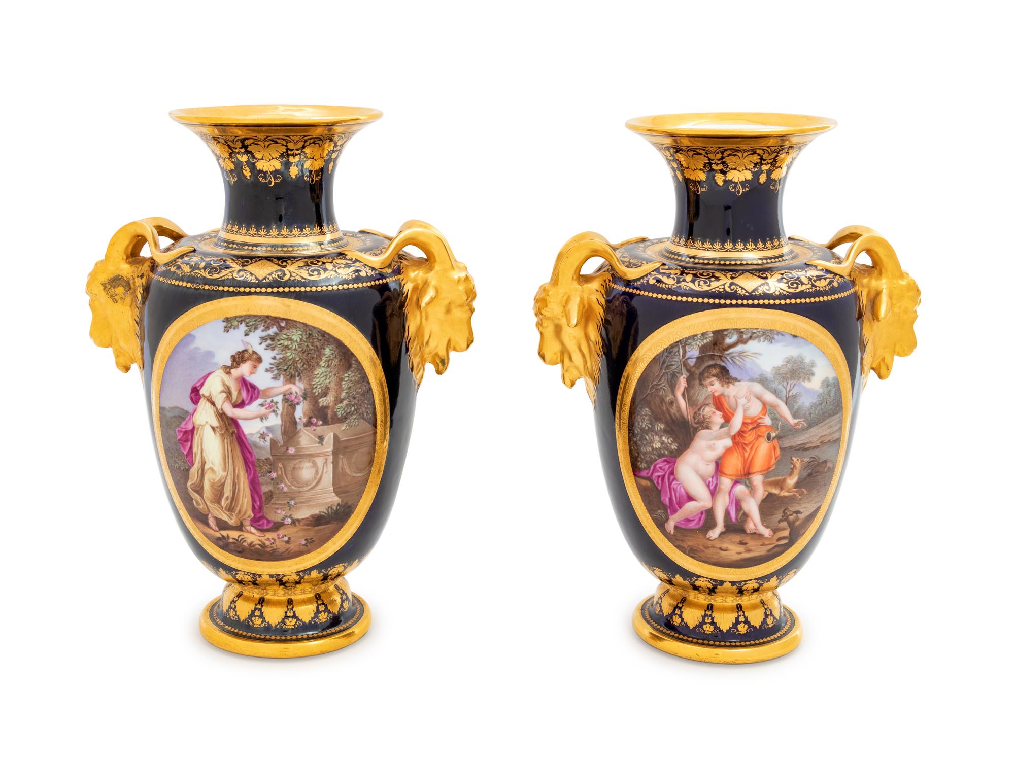 A Pair of Vienna Painted and Parcel Gilt Handled Porcelain Urns