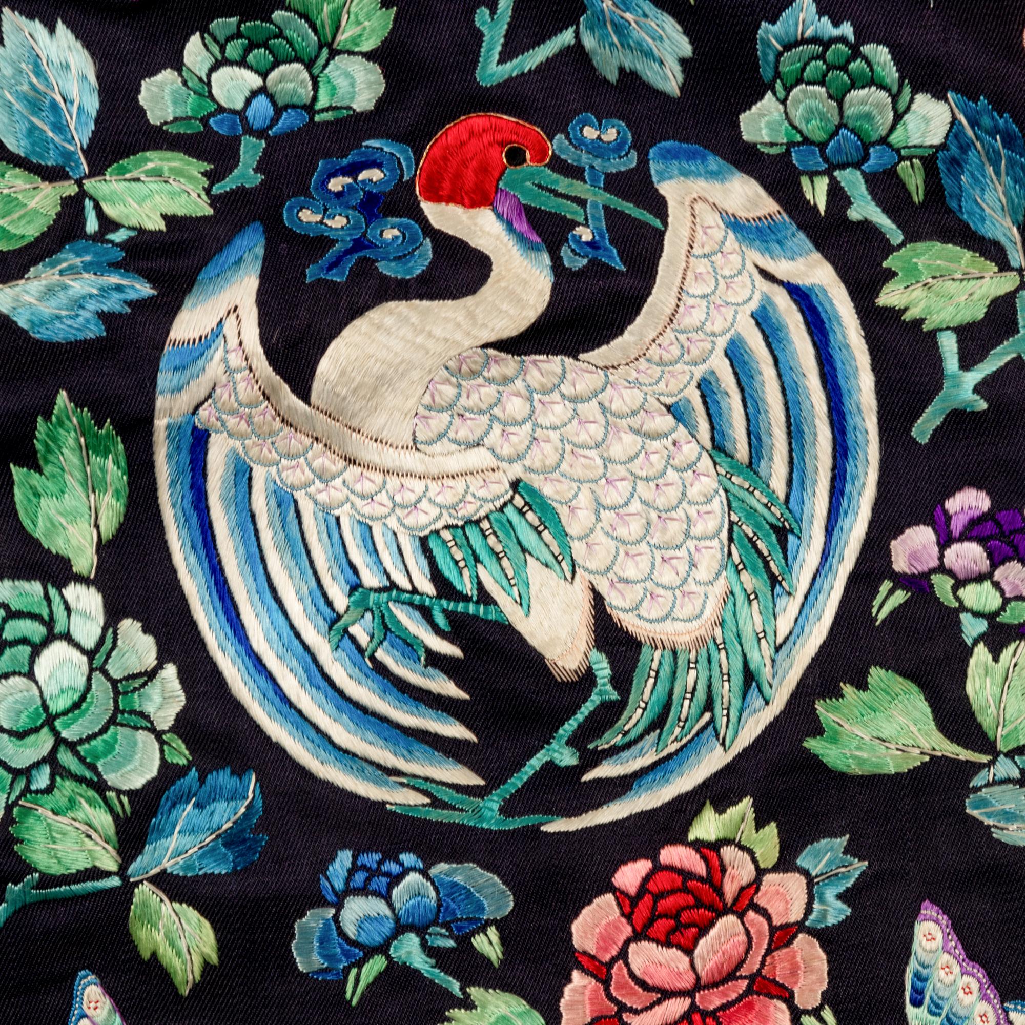 A Chinese Navy Satin Ground Embroidered Silk 'Dragon and Crane' Robe, Qiagua , Late 19th Century 清晚期 石青緞地綉龍紋團鶴紋袷褂