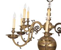 A Baroque Style Brass Twelve-Light Chandelier