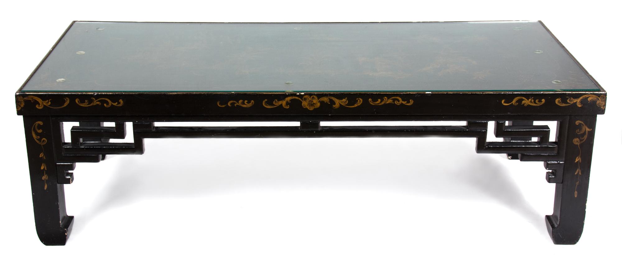 A Black and Gilt Lacquered Low Table Height 16 x width 51 1/2 x depth 24 1/2 inches. — 20TH CENTURY