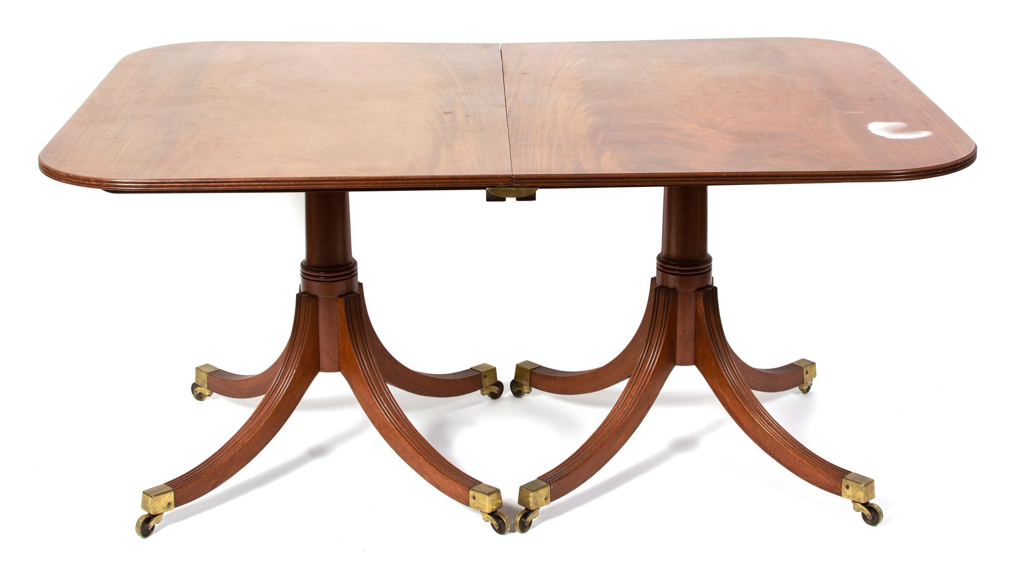 A Regency Style Two Pedestal Mahogany Dining Table Height 28 1/2 x width 59 3/4 x depth 42 1/4 inches. — EARLY 20TH CENTURY