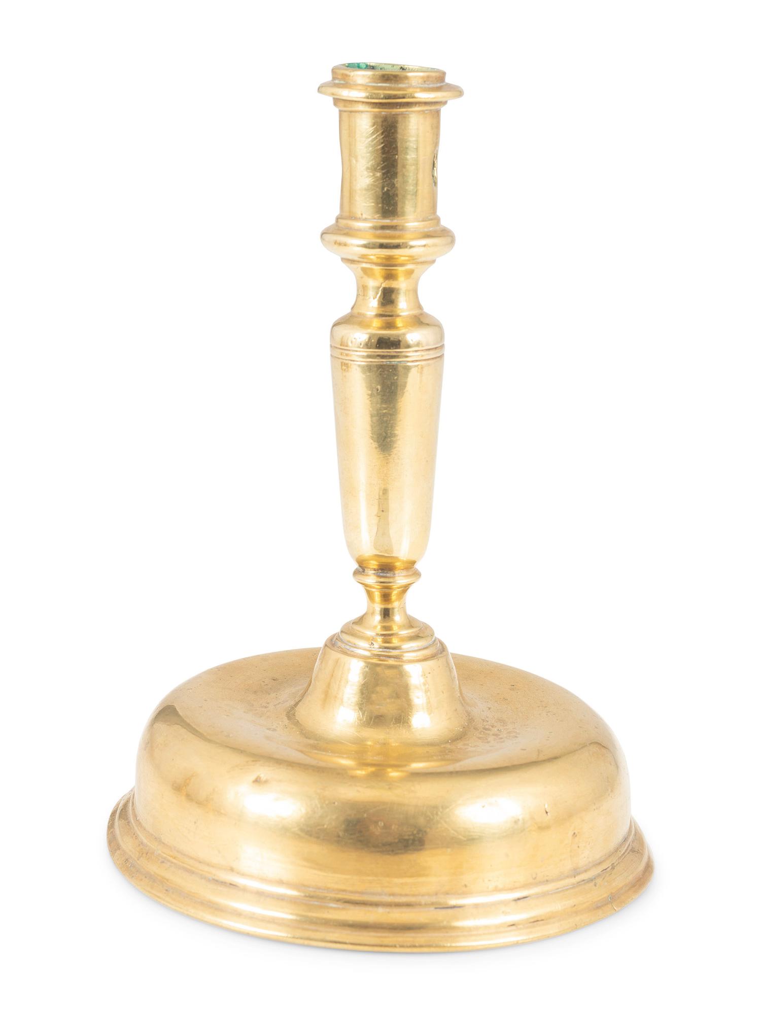 A Continental Brass Bell-Bottom Candlestick