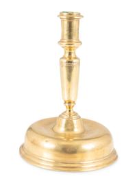 A Continental Brass Bell-Bottom Candlestick