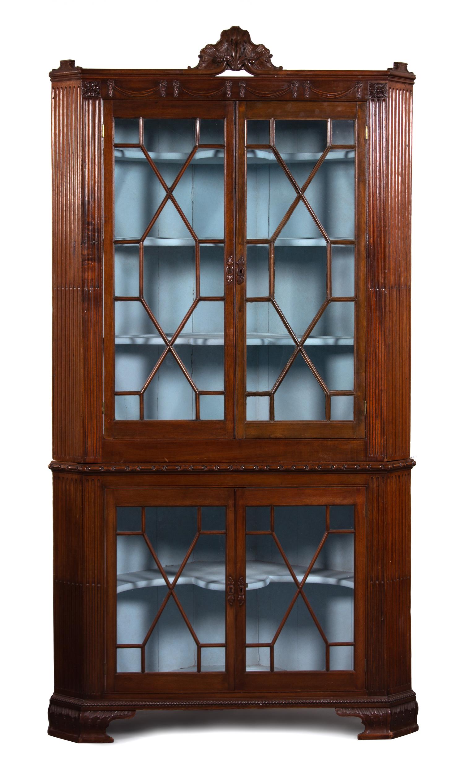 A Regency Carved Mahogany Corner Cabinet Height 87 1/2 x width 44 x depth 24 inches. — 19TH CENTURY