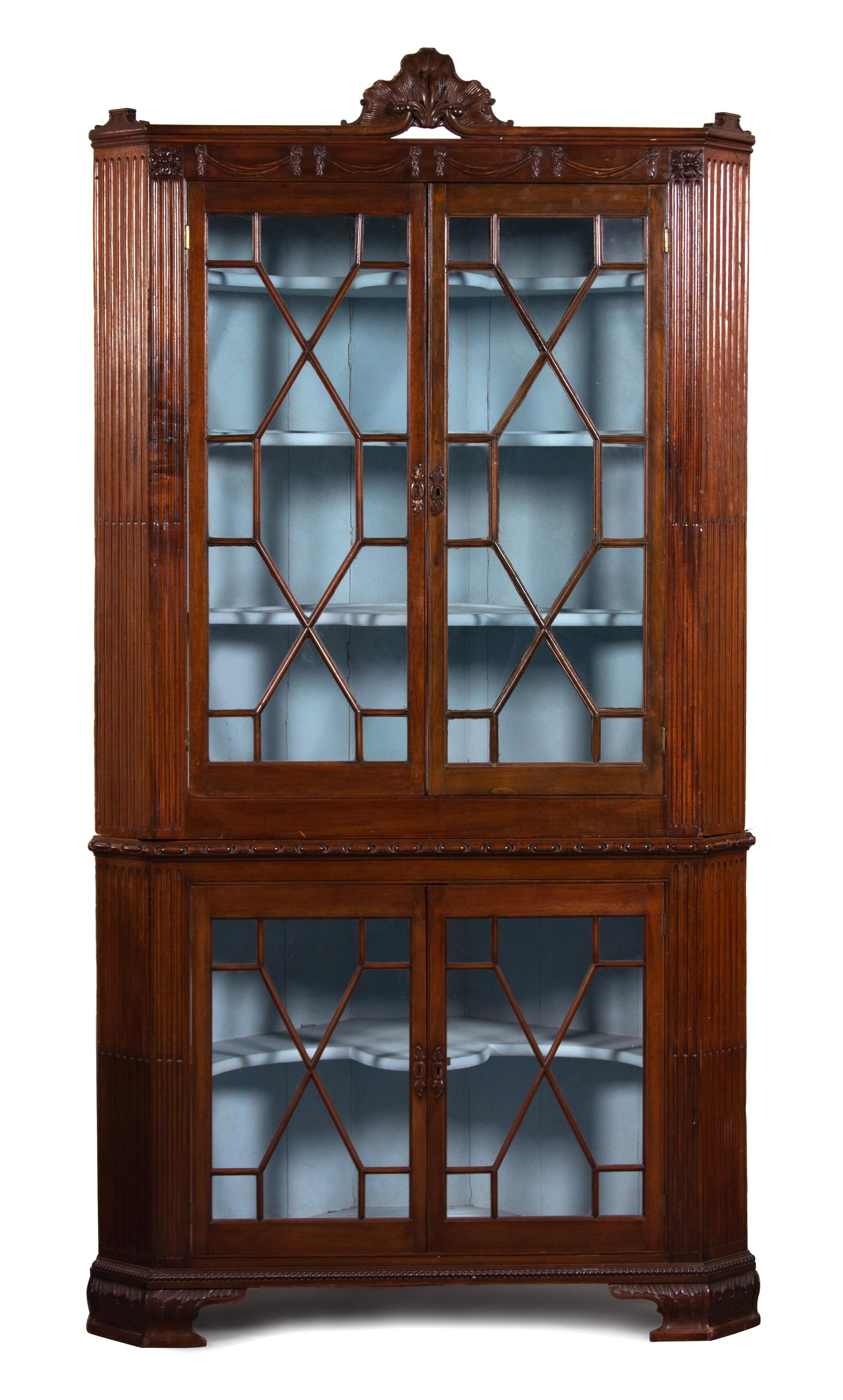 A Regency Carved Mahogany Corner Cabinet Height 87 1/2 x width 44 x depth 24 inches. — 19TH CENTURY