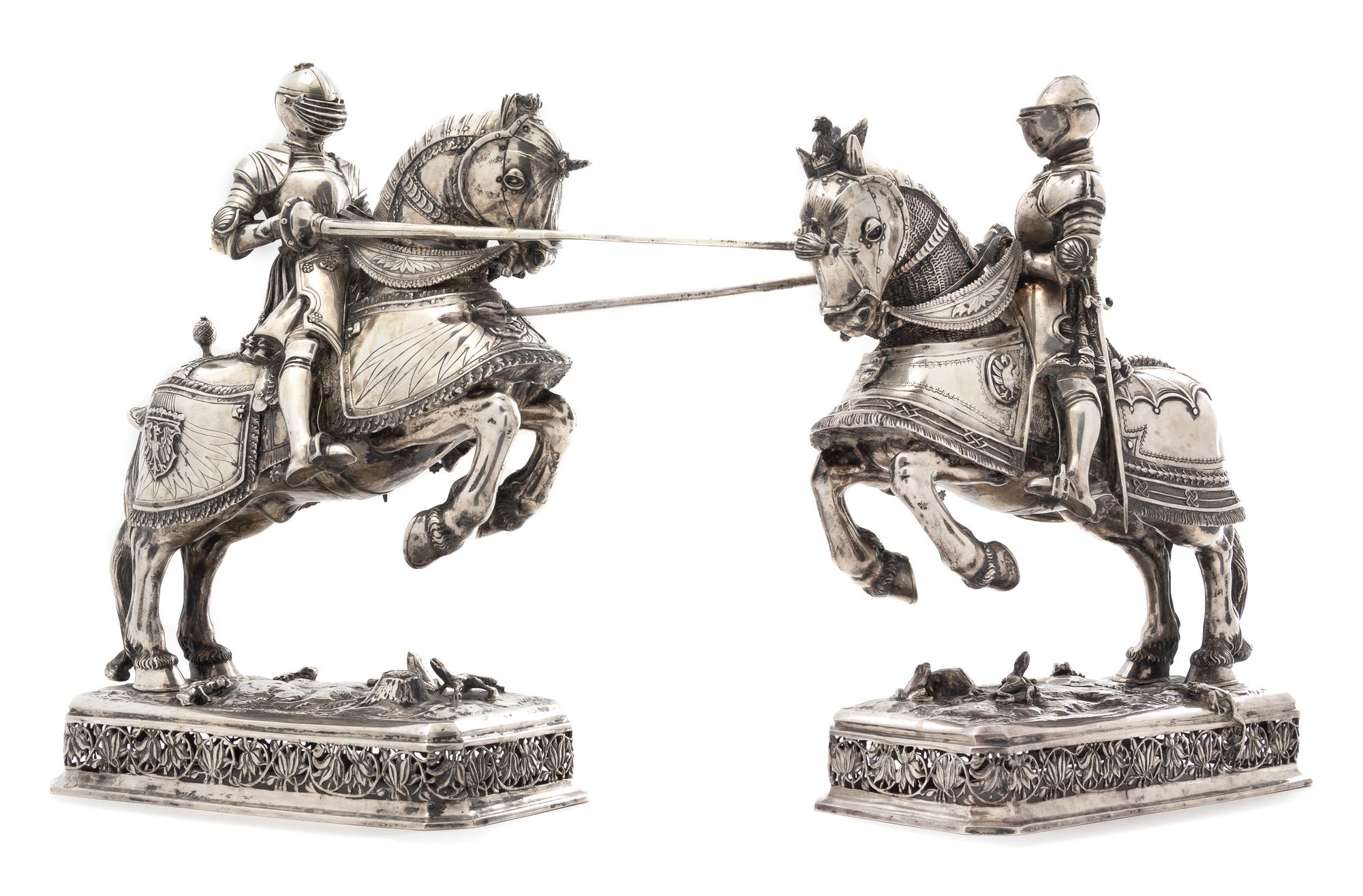 A Pair of German Silver Equestrian Groups, Ludwig Neresheimer, Hanau, Late 19th/Early 20th Century, each in the form of a charging knig