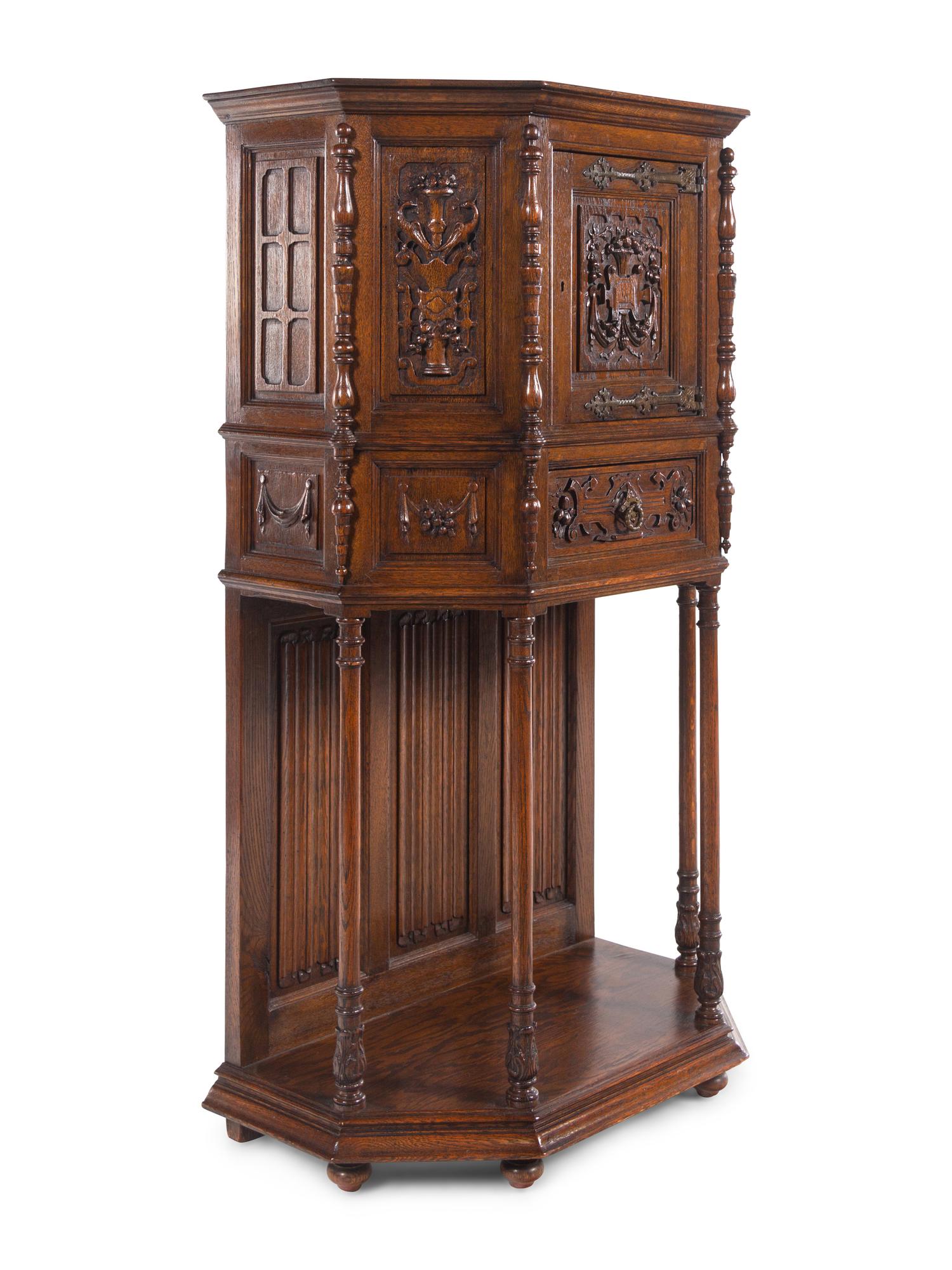 A Gothic Revival Carved Oak Cabinet on Stand